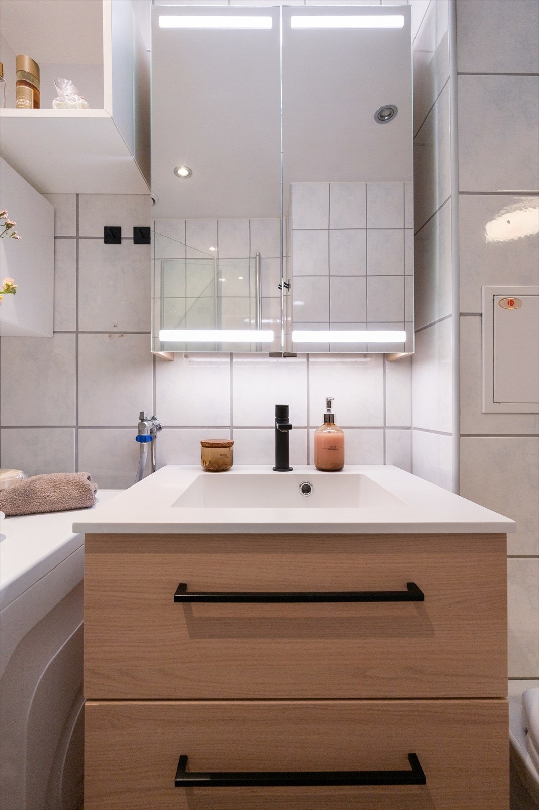 Badet har også opplegg for vaskemaskin, praktiske skuffer under servant og speil med integrert belysning. Galleribilde