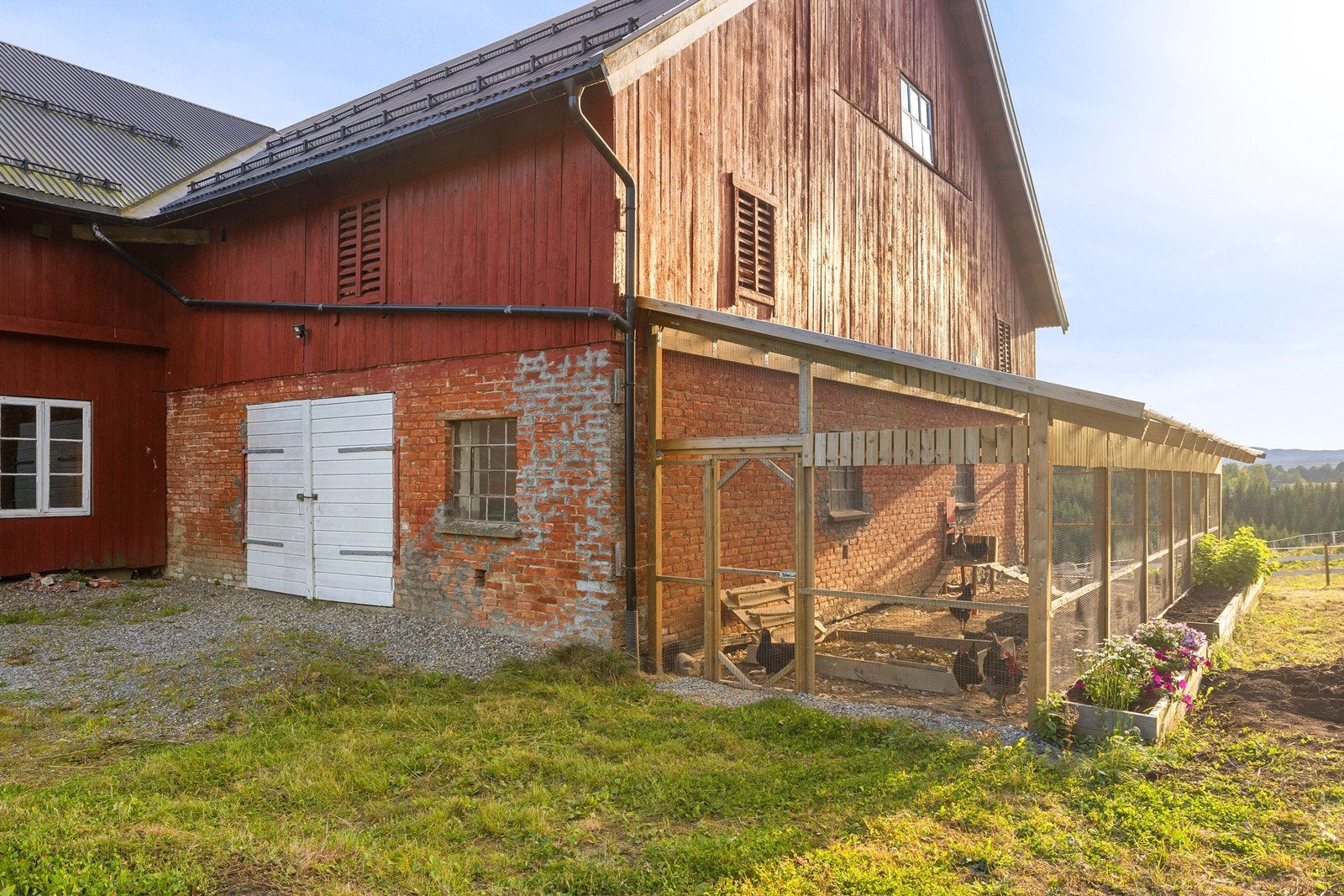 Låven er bygget i tradisjonell stil. Det er etablert hønsegård på siden av bygget. Galleribilde