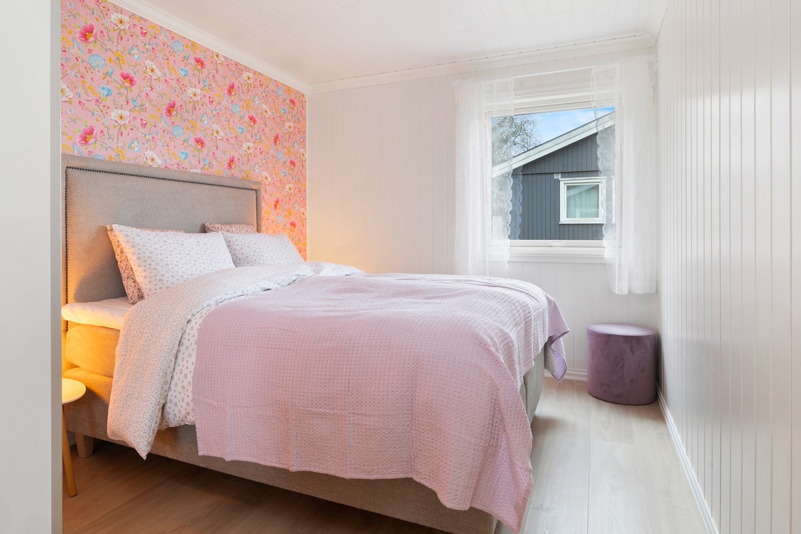 Romslig lyst soverom med kontrastvegg. God plass til oppbevaring i garderobeskap. Galleribilde