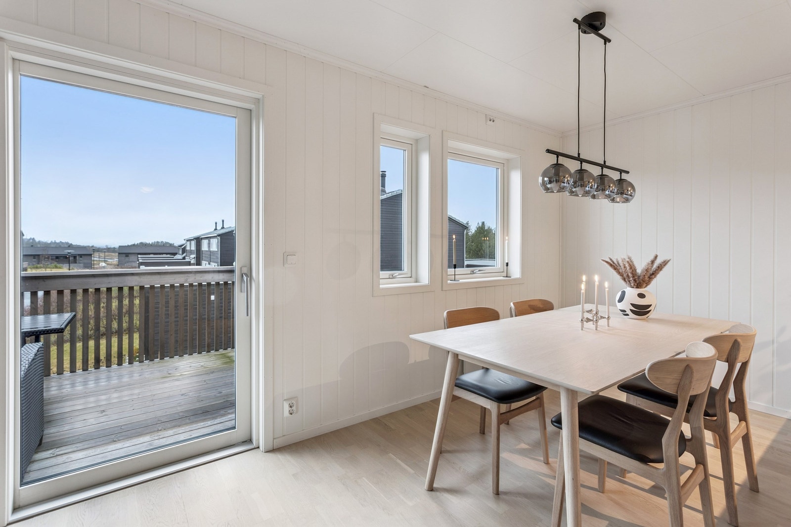 Skyvedøren i malt utførelse med isolerglass visker ut skillet mellom inne og ute. Galleribilde