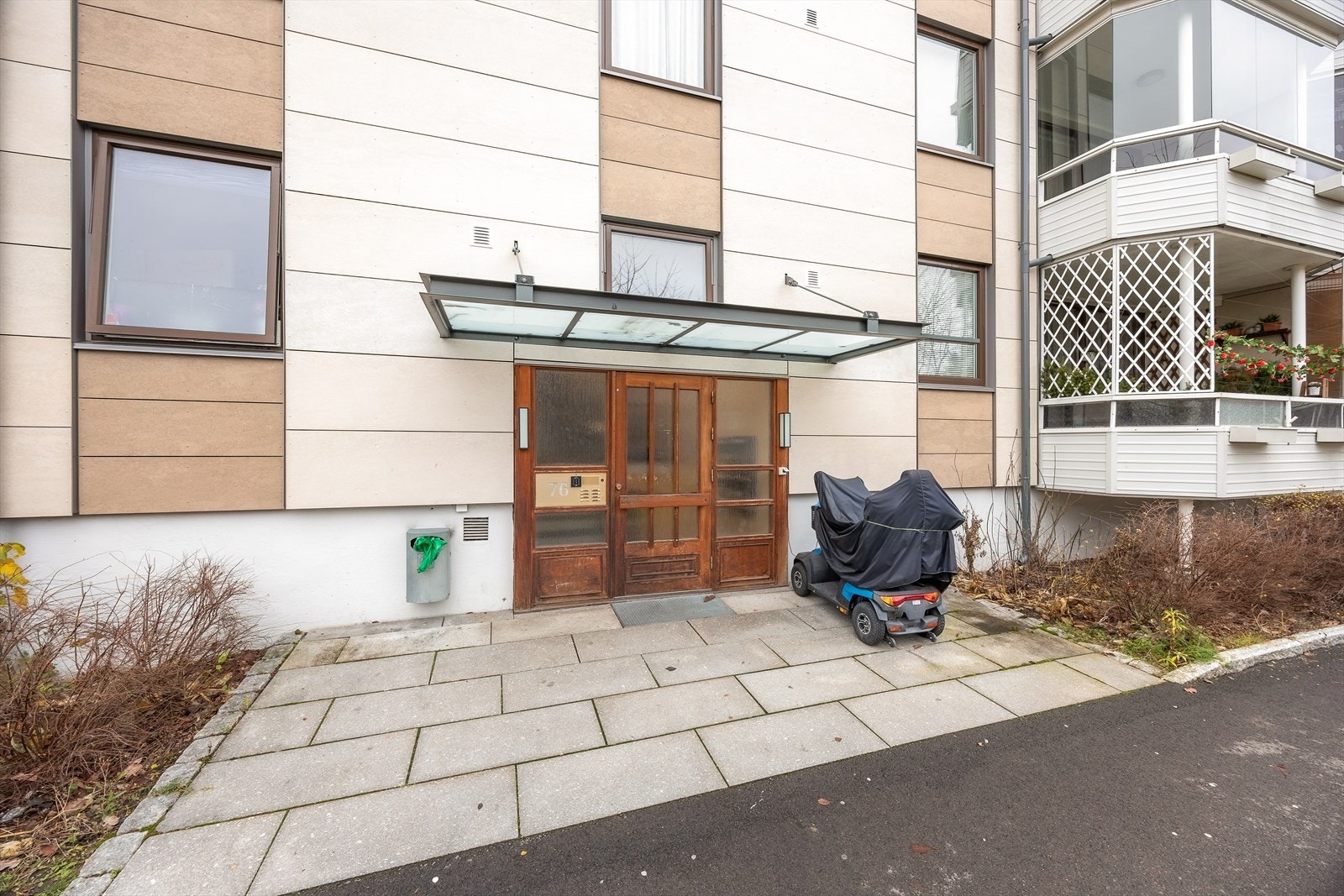 Overbygget inngangsparti med adkomst til leiligheten via svalgang. Galleribilde