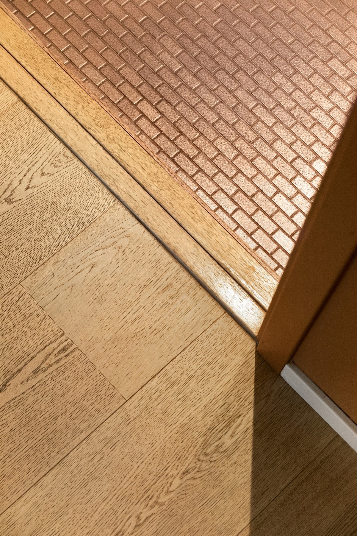 Flott overgang mellom tregulv på stue/kjøkken og lekkert, flisbelagt gulv i entreen. Galleribilde