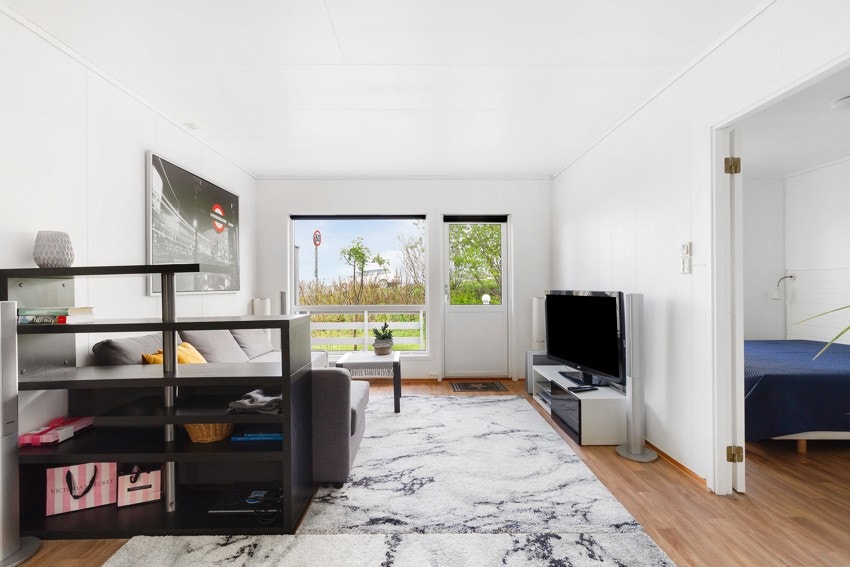 Romslig stue med plass for flere sittegrupper. Galleribilde