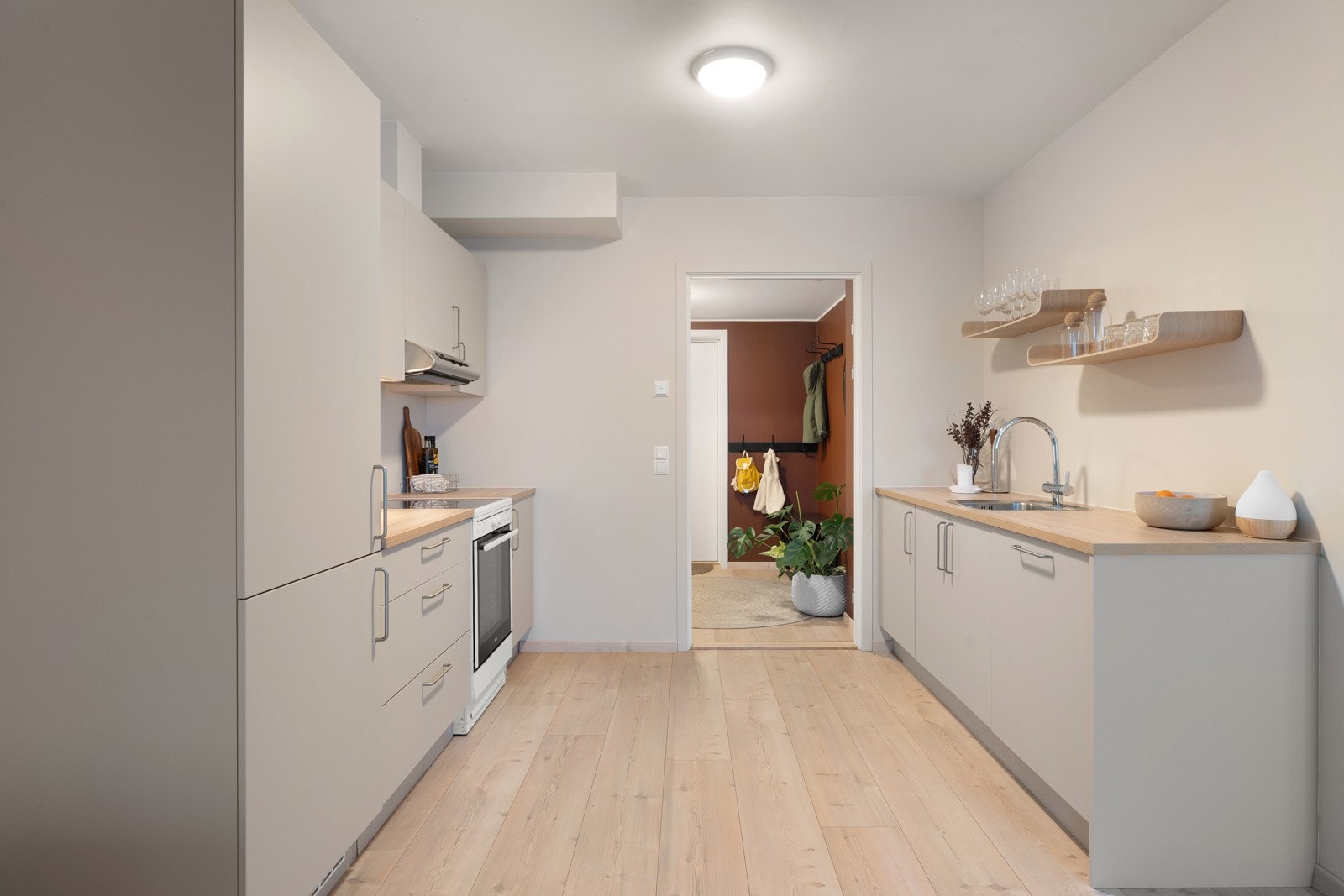 Delikat kjøkken med slette fronter og godt med arbeidsplass på kjøkkenbenk.