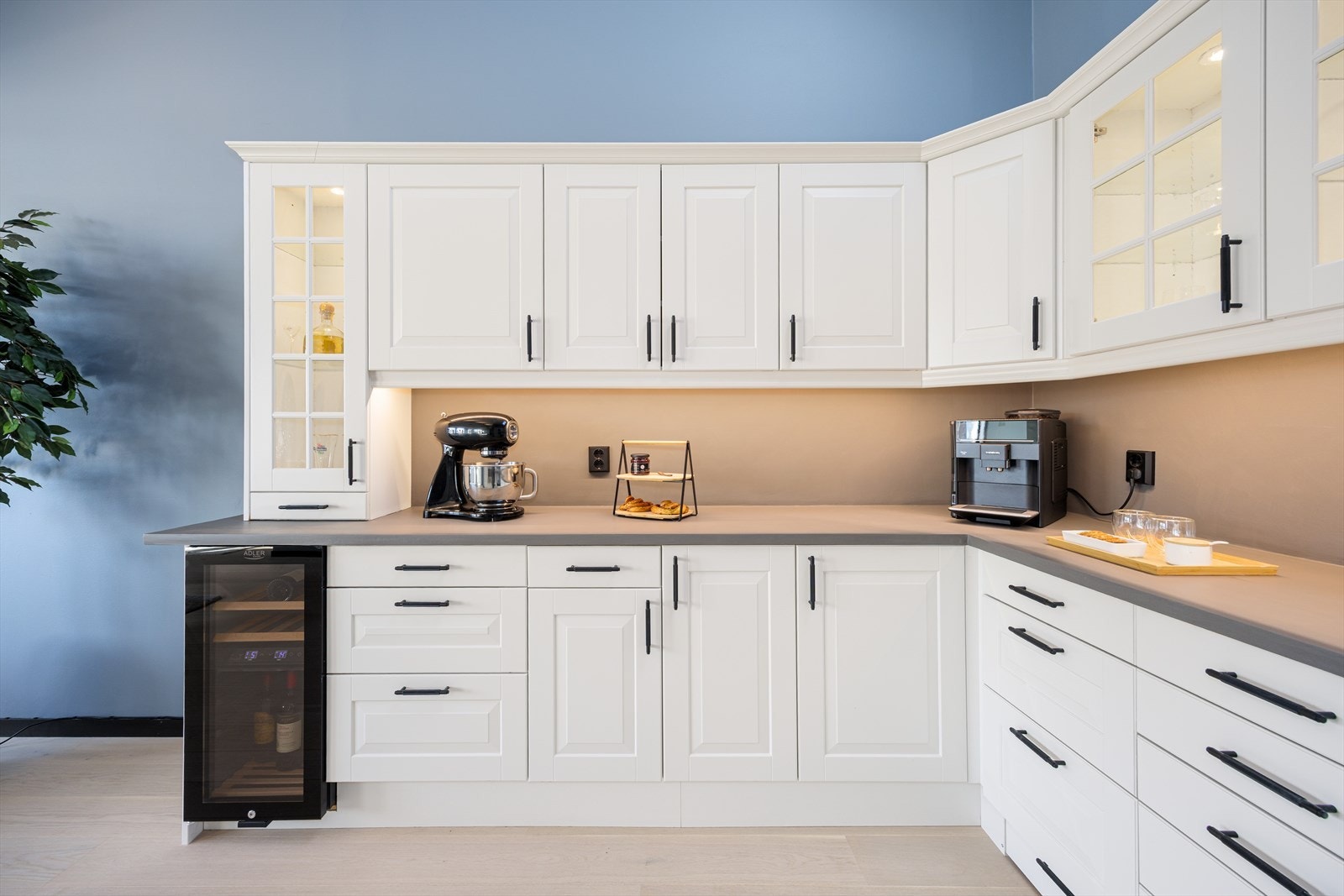 Delikat kjøkken med rikelig skapplass, integrerte hvitevarer og et stilrent vinskap - perfekt for deg som setter pris på både kvalitet og estetikk. Galleribilde