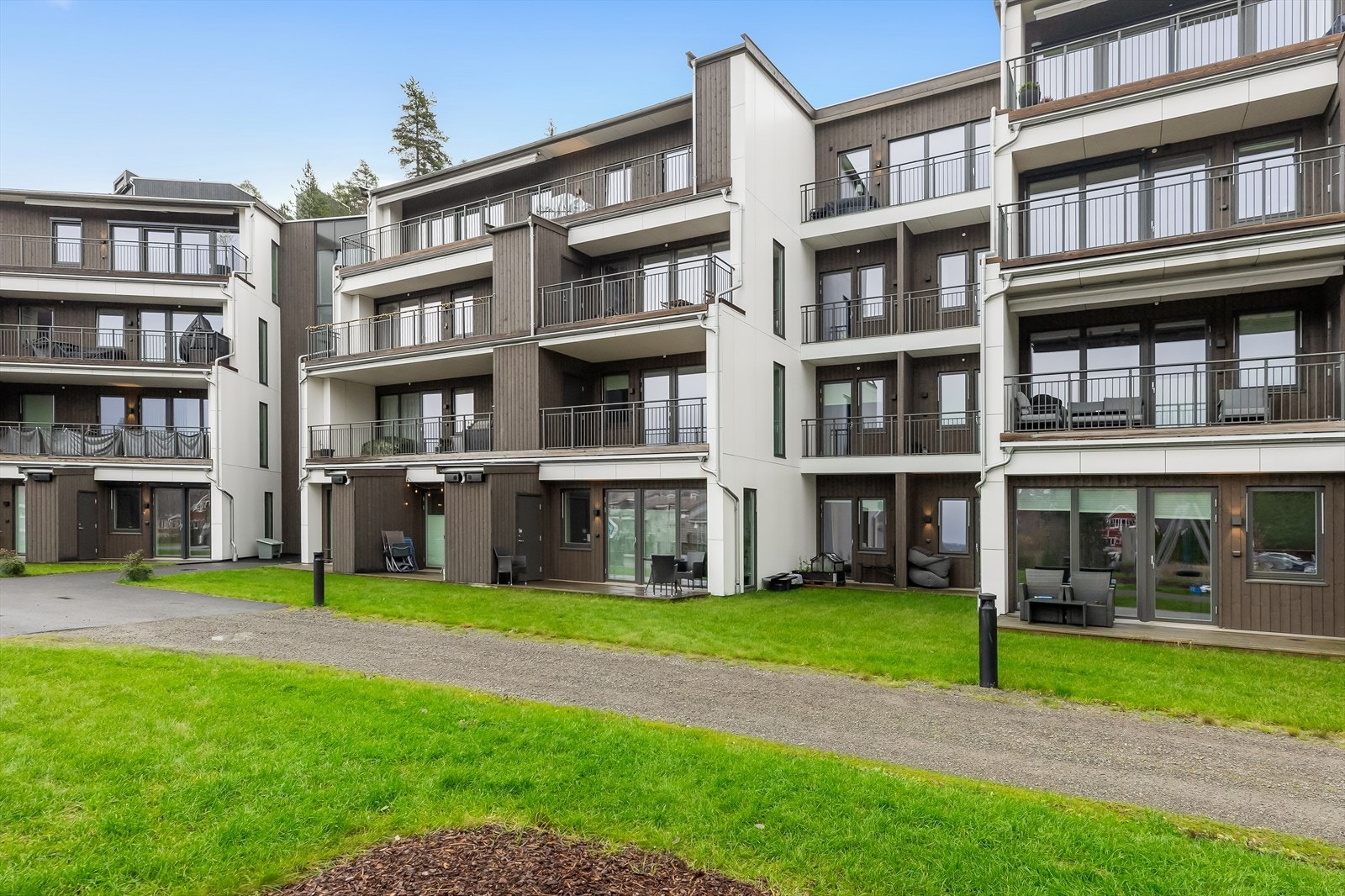 Tomten er pent opparbeidet med gressplen, forstøtningsmurer og asfalt. Ved inngangspartiet er det opparbeidet fellesområde med lekeapparater og sittegrupper til glede for beboerne. Galleribilde