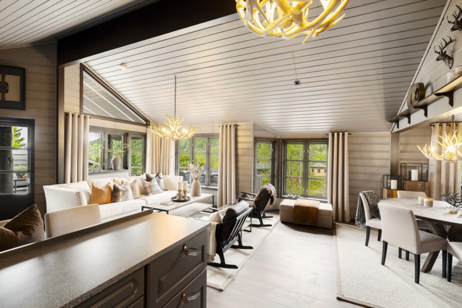 Kjøkkeninnredningen er malt i en grå, kledelig farge og har grå laminatbenkeplater. Galleribilde