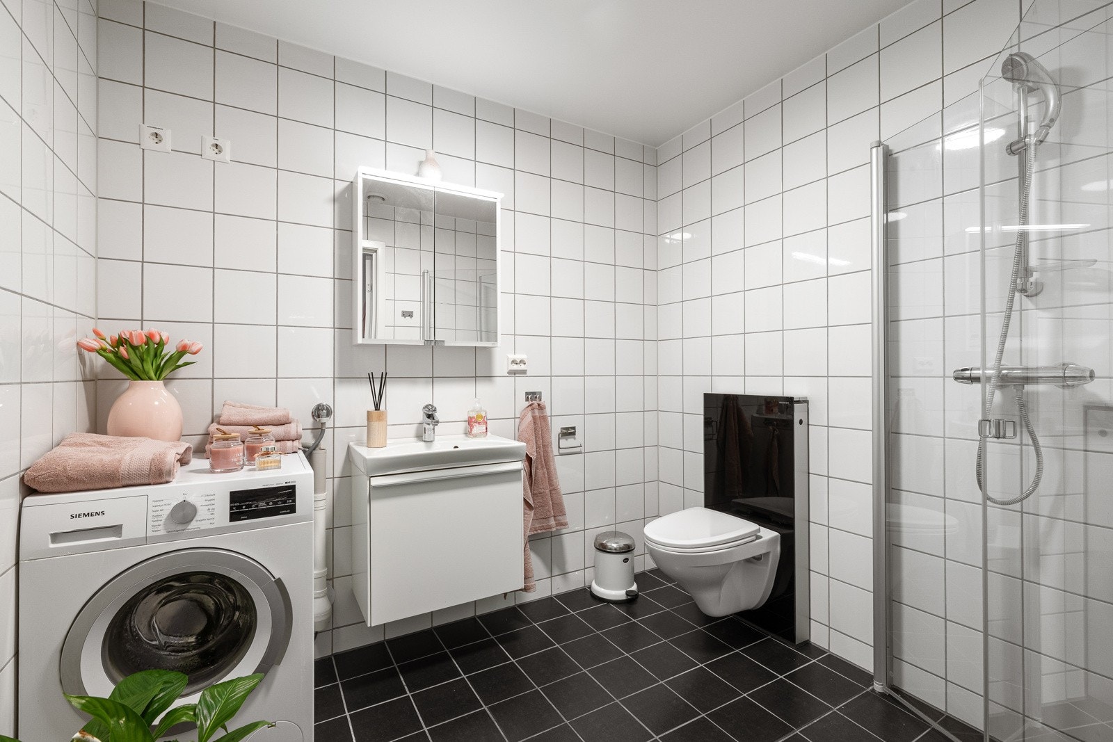 Badet fremstår som et moderne og helhetlig rom fra byggeåret 2015, med helflisede flater som gir et tidløst og rent uttrykk. Galleribilde