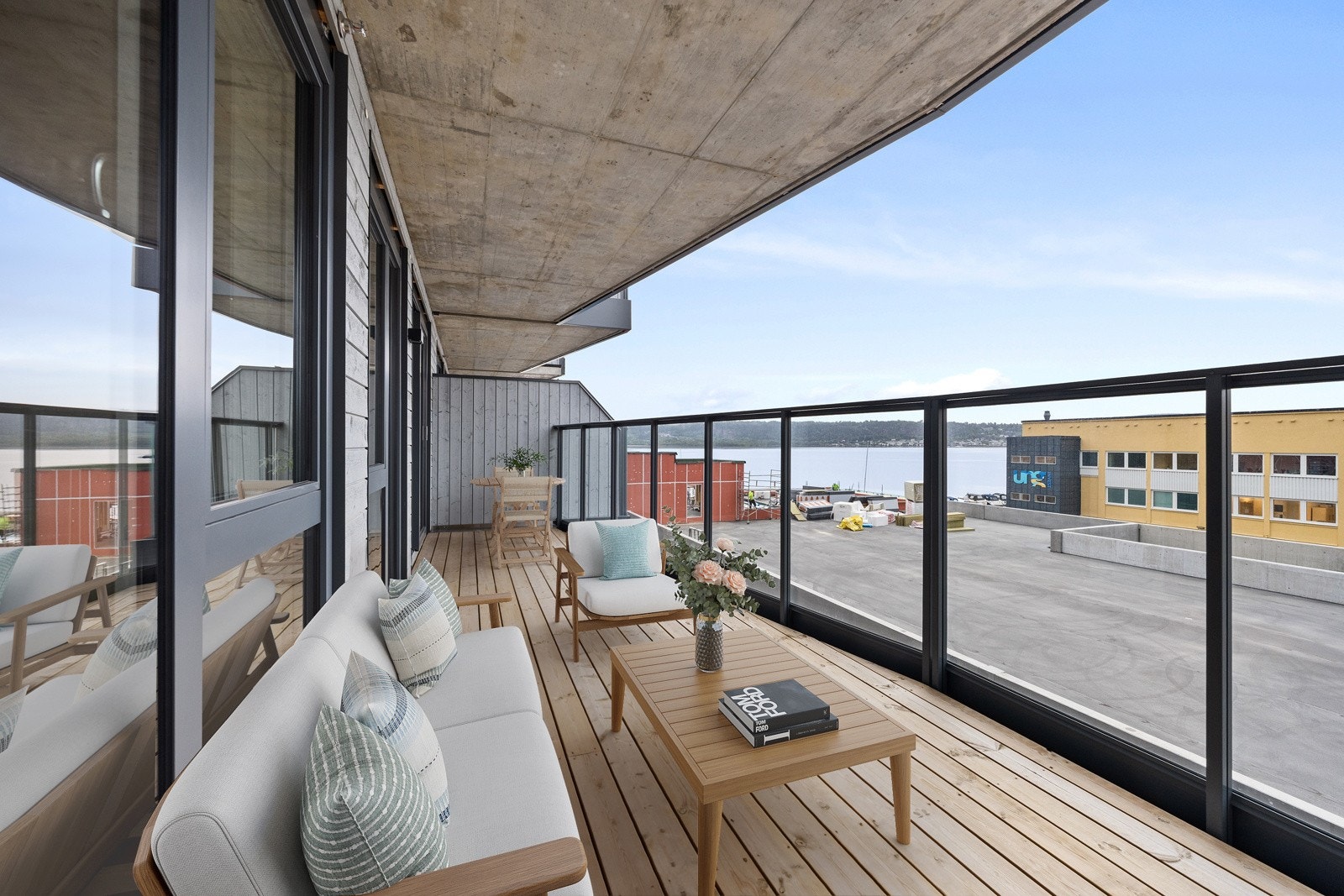 Stor balkong med morgensol og utsikt mot fjorden. Galleribilde