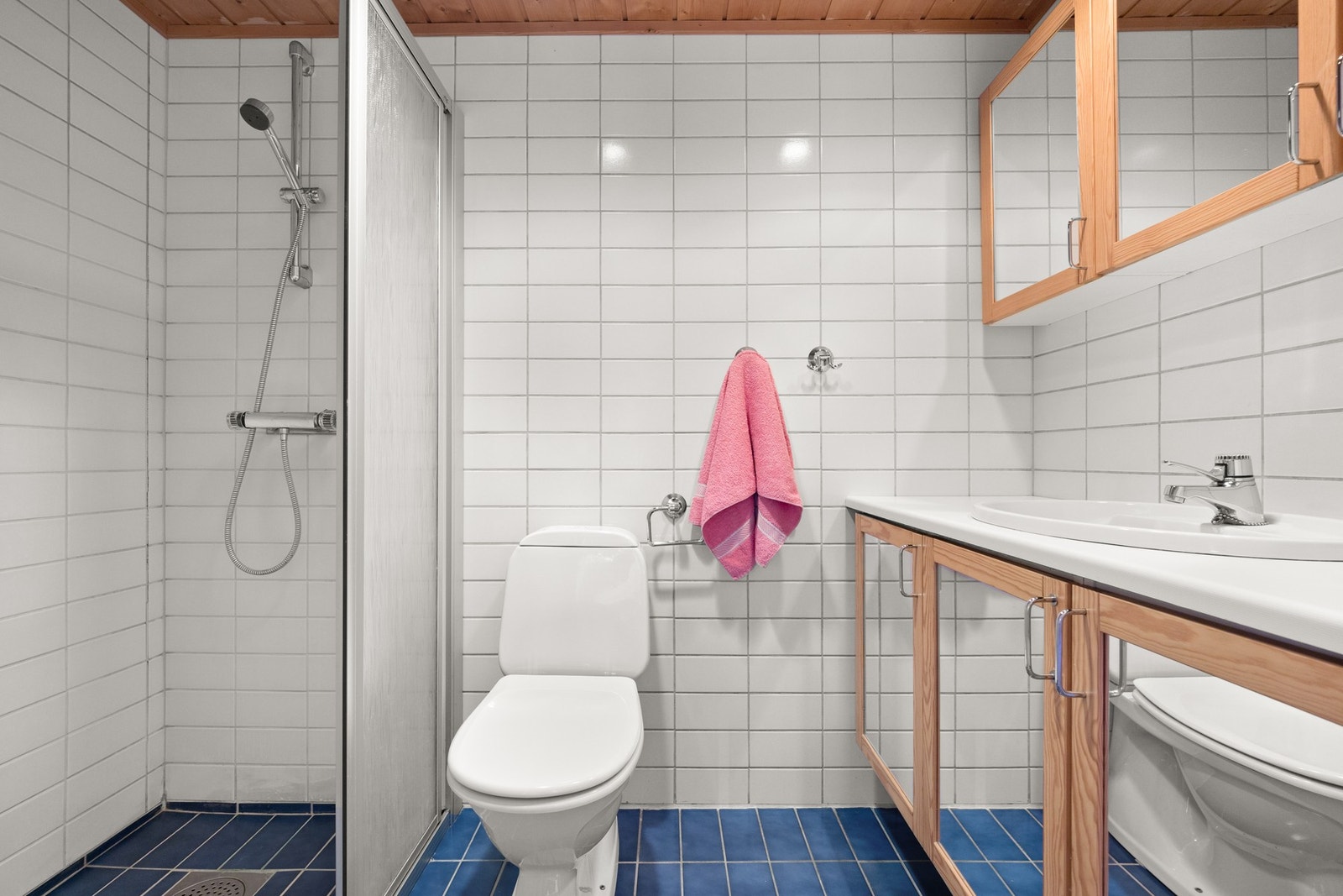 Badene i underetasje er flislagt på gulv og vegger. Galleribilde