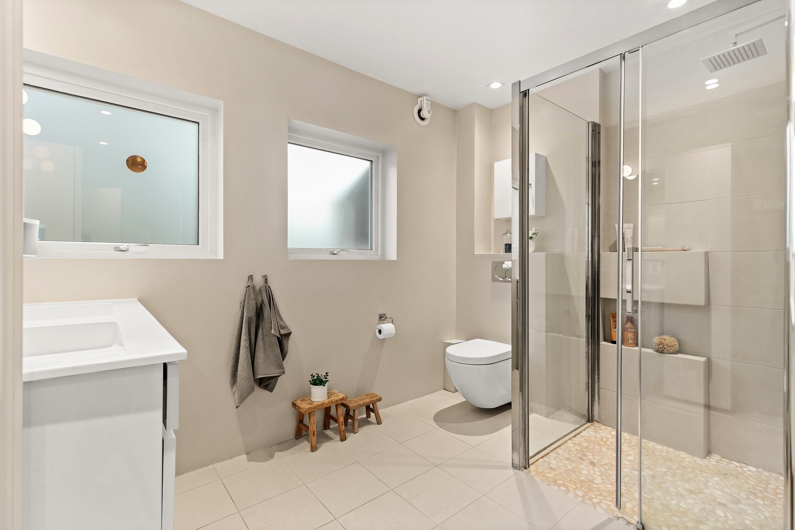 Bad i 1. etg.
Lyst og moderne bad med dusjhjørne, vegghengt toalett, servant og vindusflater Galleribilde