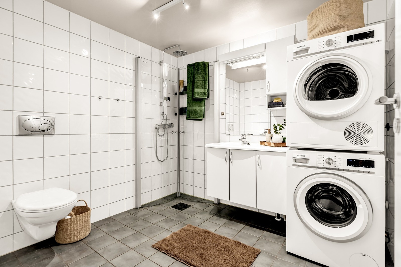 Stort flislagt baderom med opplegg for vask/tørk Galleribilde