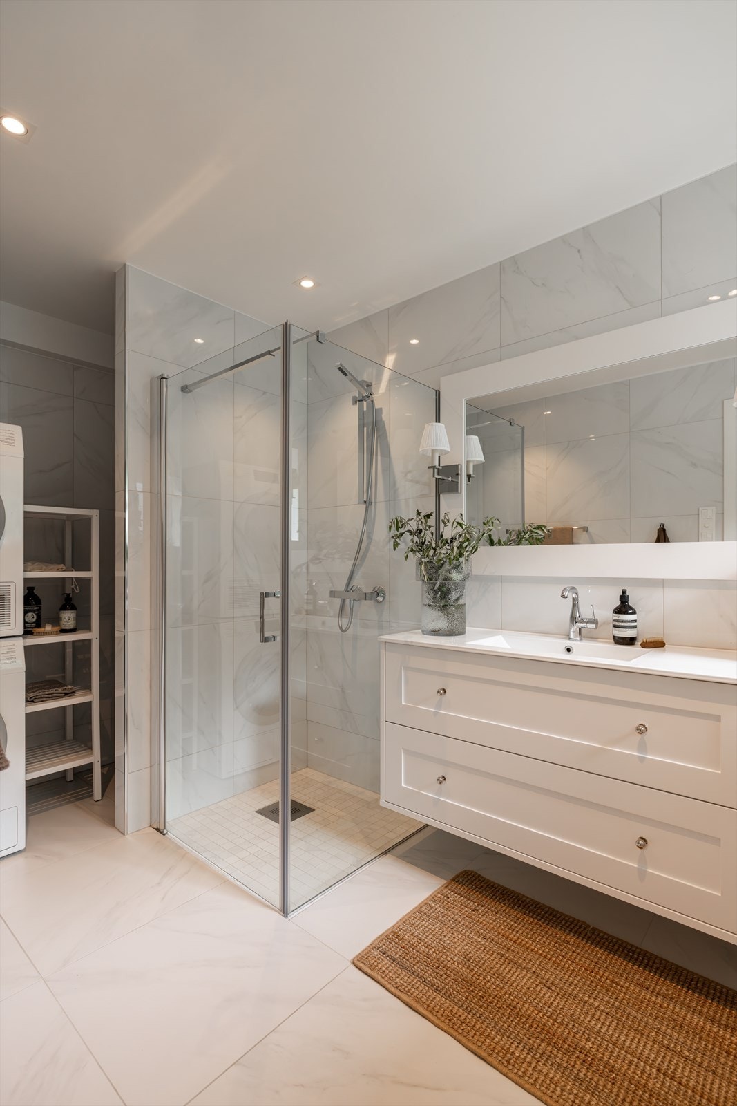 Badet er innredet med vegghengt toalett, dusjhjørne med innfellbare glassdører, og et klassisk servantskap (120 cm) med profilerte fronter og integrert servant. Galleribilde