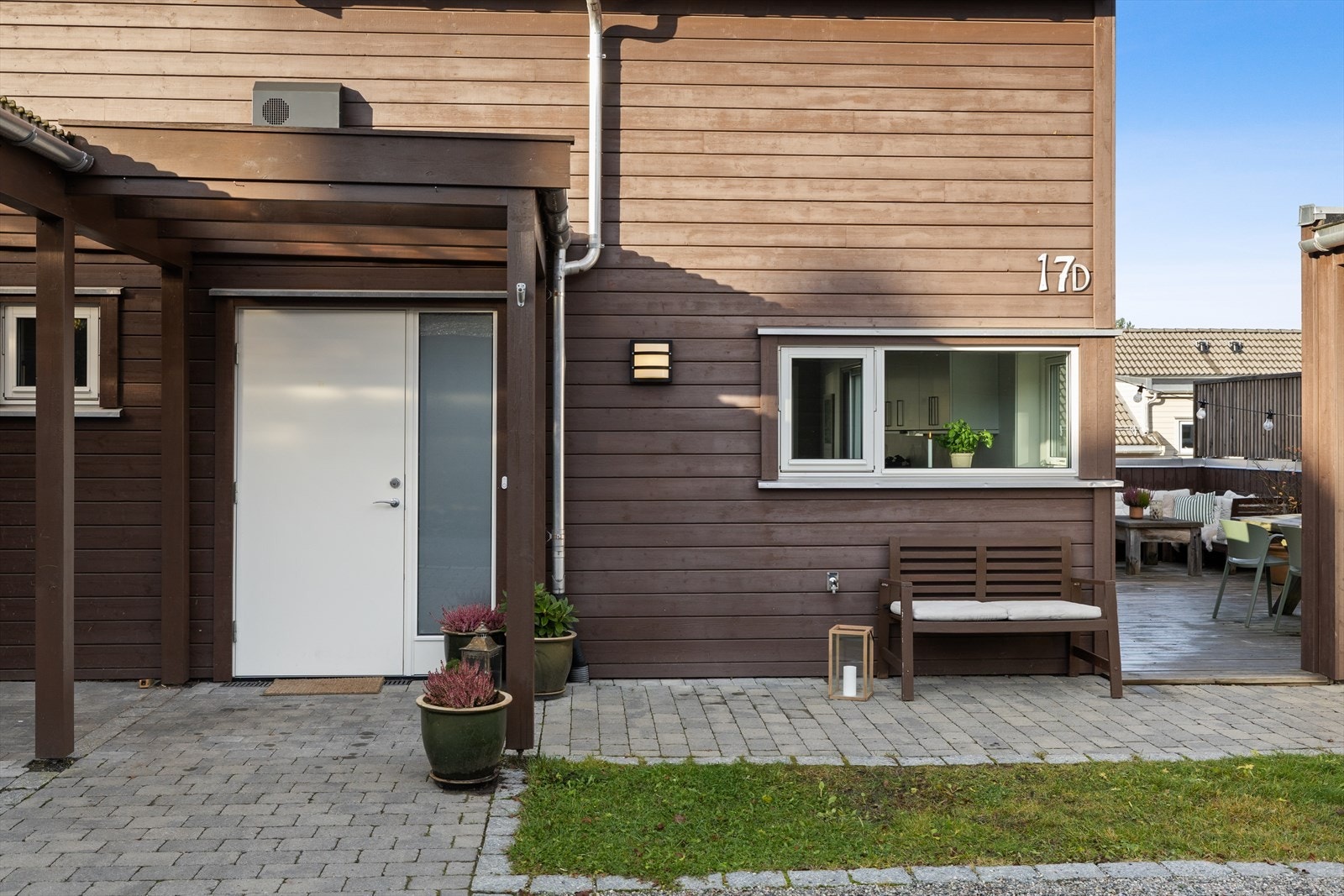 Inngangspartiet er pent opparbeidet med belegningsstein, grus og innslag av grønt gress, som gir et ryddig og innbydende førsteinntrykk. Galleribilde