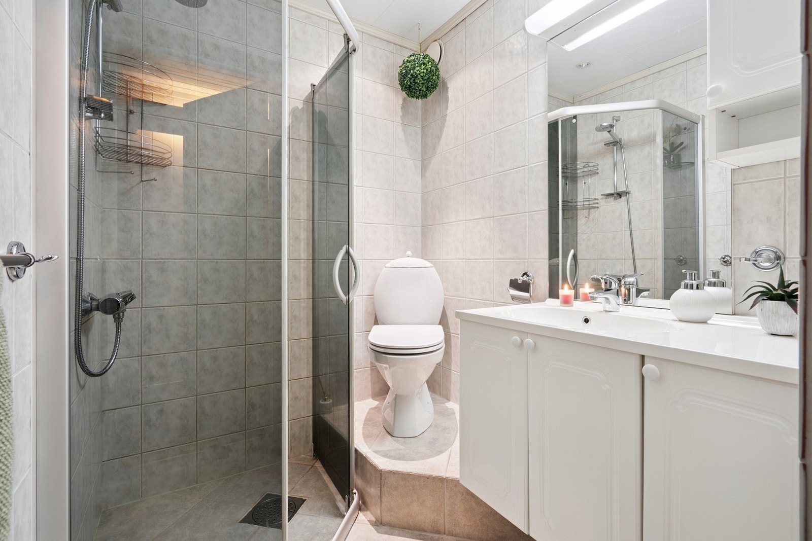 Praktisk flislagt baderom i sokkeletasje, med elektrisk gulvvarmer. Galleribilde