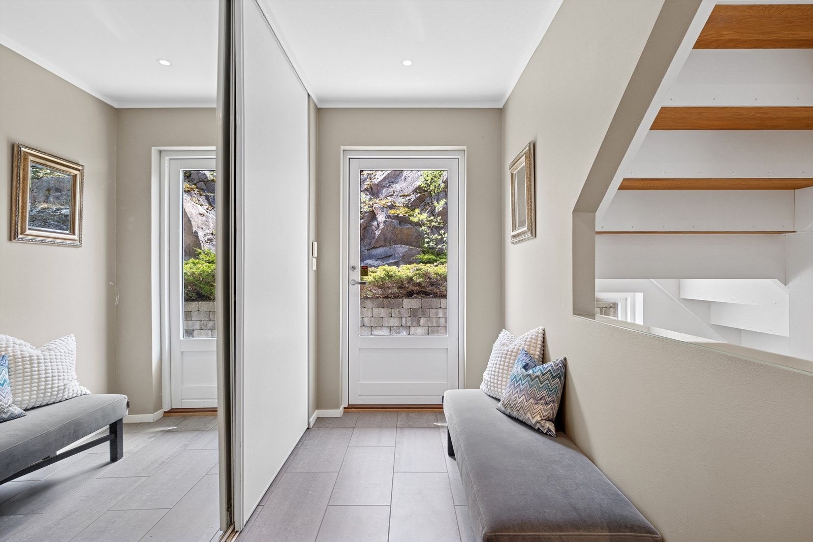 Her ønskes du velkommen inn i en lys entré med god plass til å oppbevare ytterklær og sko i stor skyvedørsgarderobe. Legg merke til de flotte omgivelsen ute igjennom glassdøren. Galleribilde