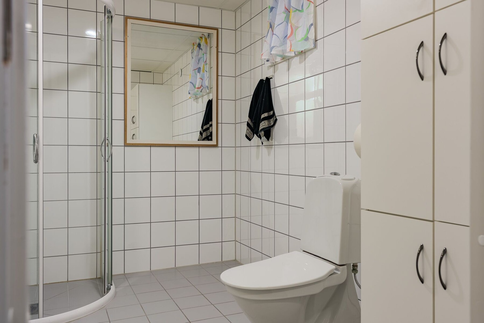 Badet er utstyrt med baderomsinnredning, dujsplass, toalett og opplegg for vaskemaskin Galleribilde