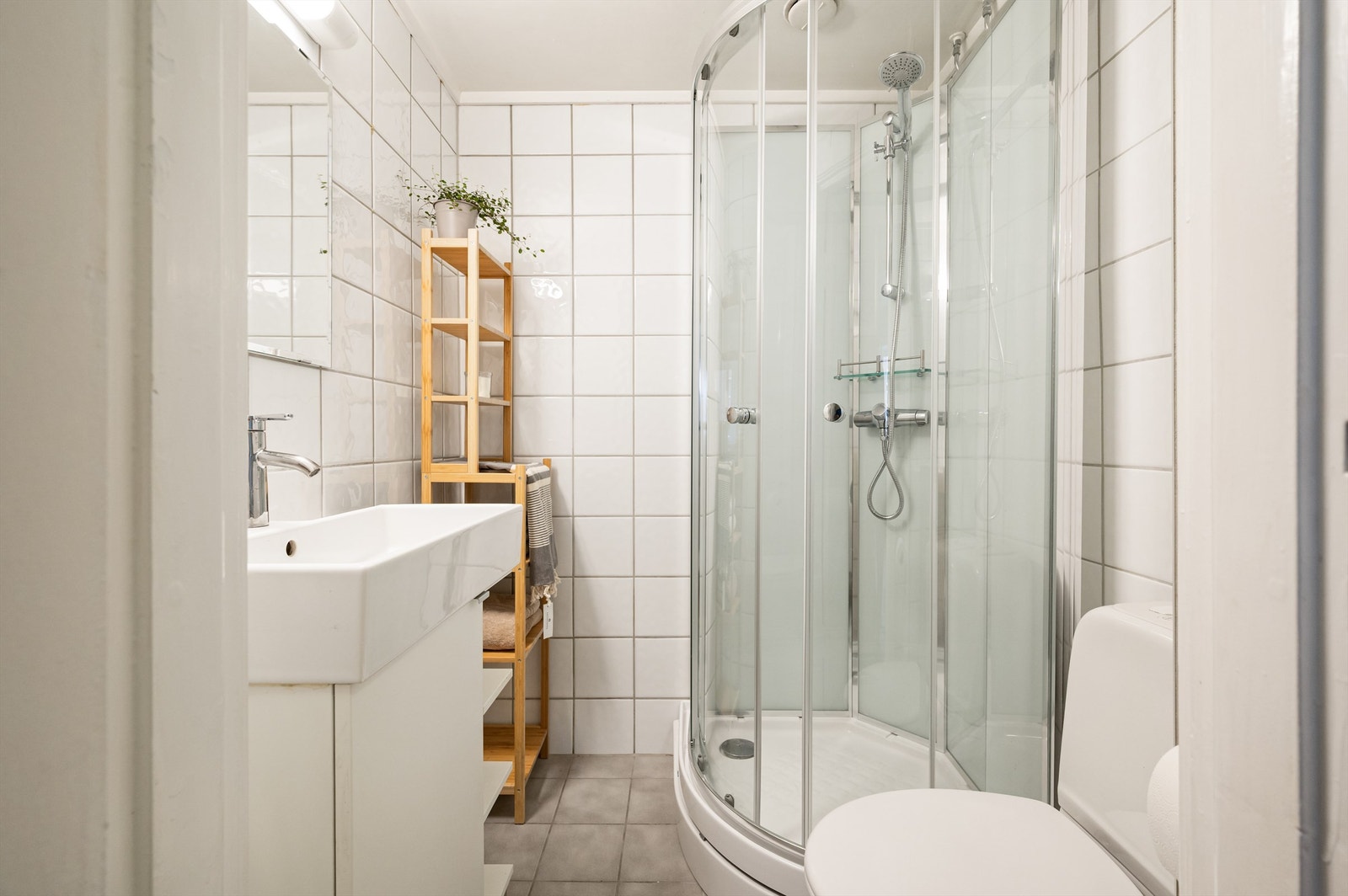 Pent flislagt bad med elektrisk gulvvarme som sørger for en behagelig start på dagen. Baderomsinnredningen består vegghengt servantinnredning med servant. Galleribilde