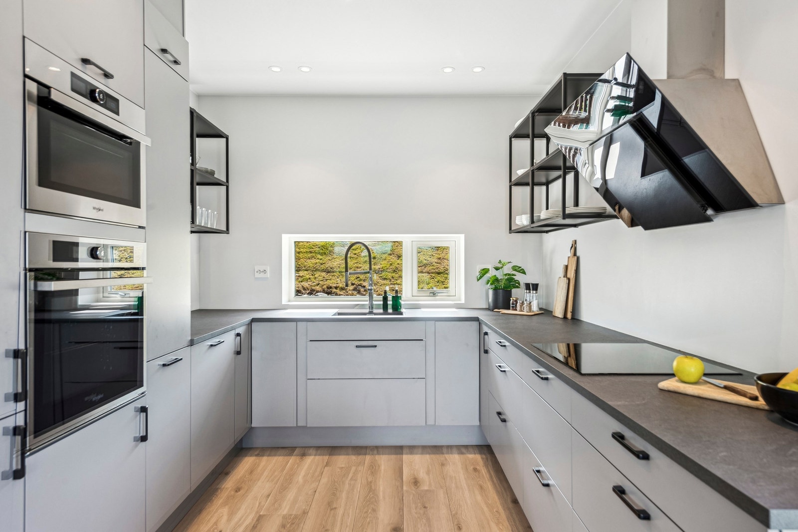 Kjøkkenet har en praktisk U-form med gode arbeidsflater, laminatbenkeplate og induksjonstopp. Galleribilde