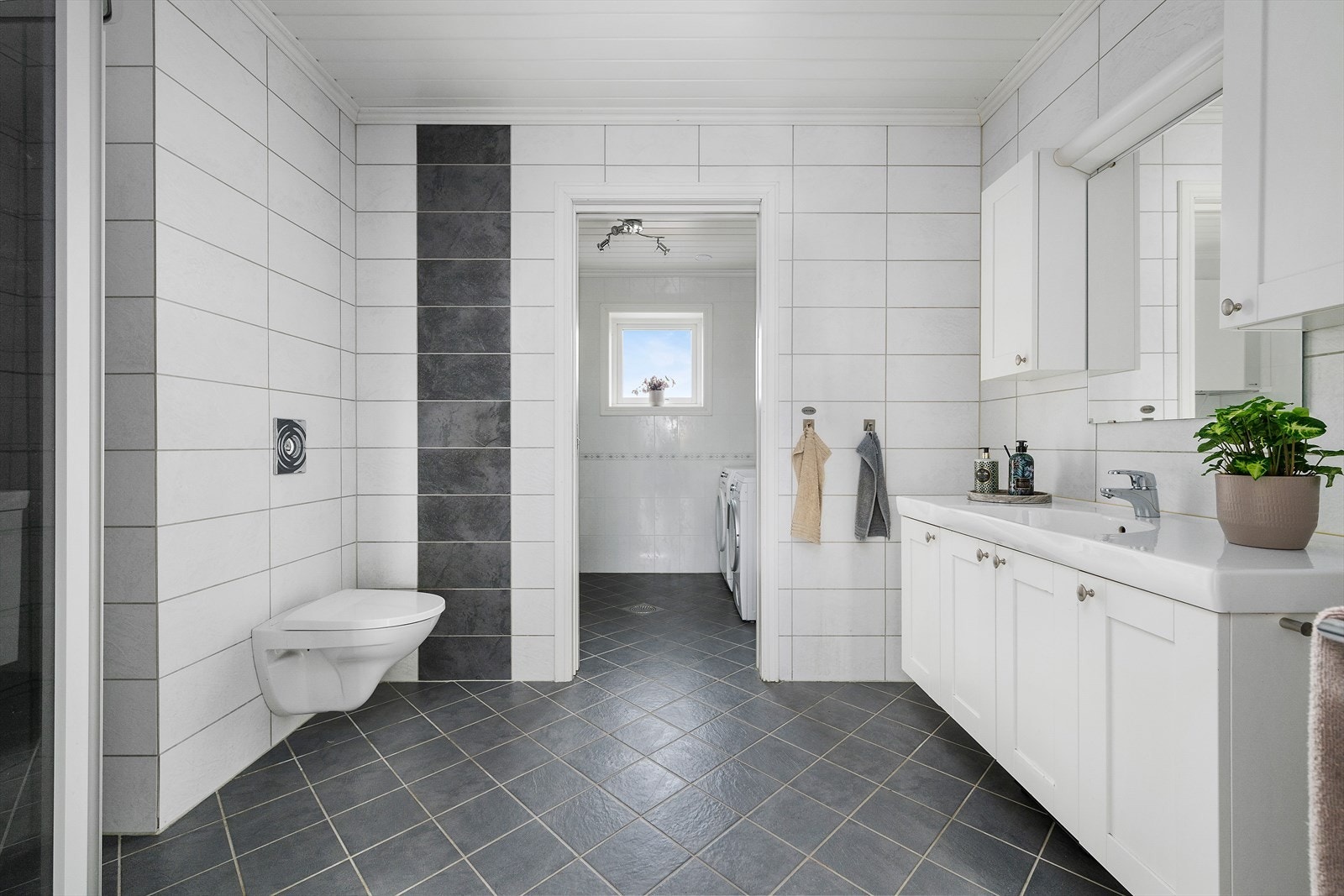 Lyst og pent bad med flislagte vegger og gulv Galleribilde