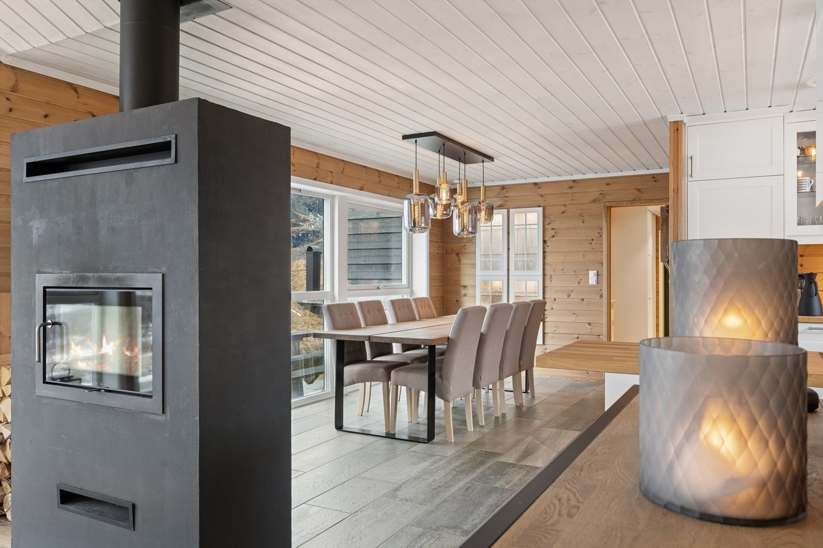 Murt peis med innsats gir varme til både spisestue og stue. Flammebildet er synlig fra begge sonene. Galleribilde