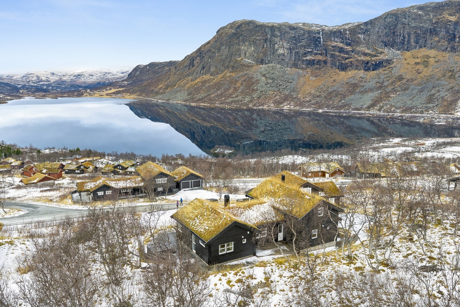 Hytta er plassert i et naturskjønt område med utsikt mot fjell og innsjø. Galleribilde
