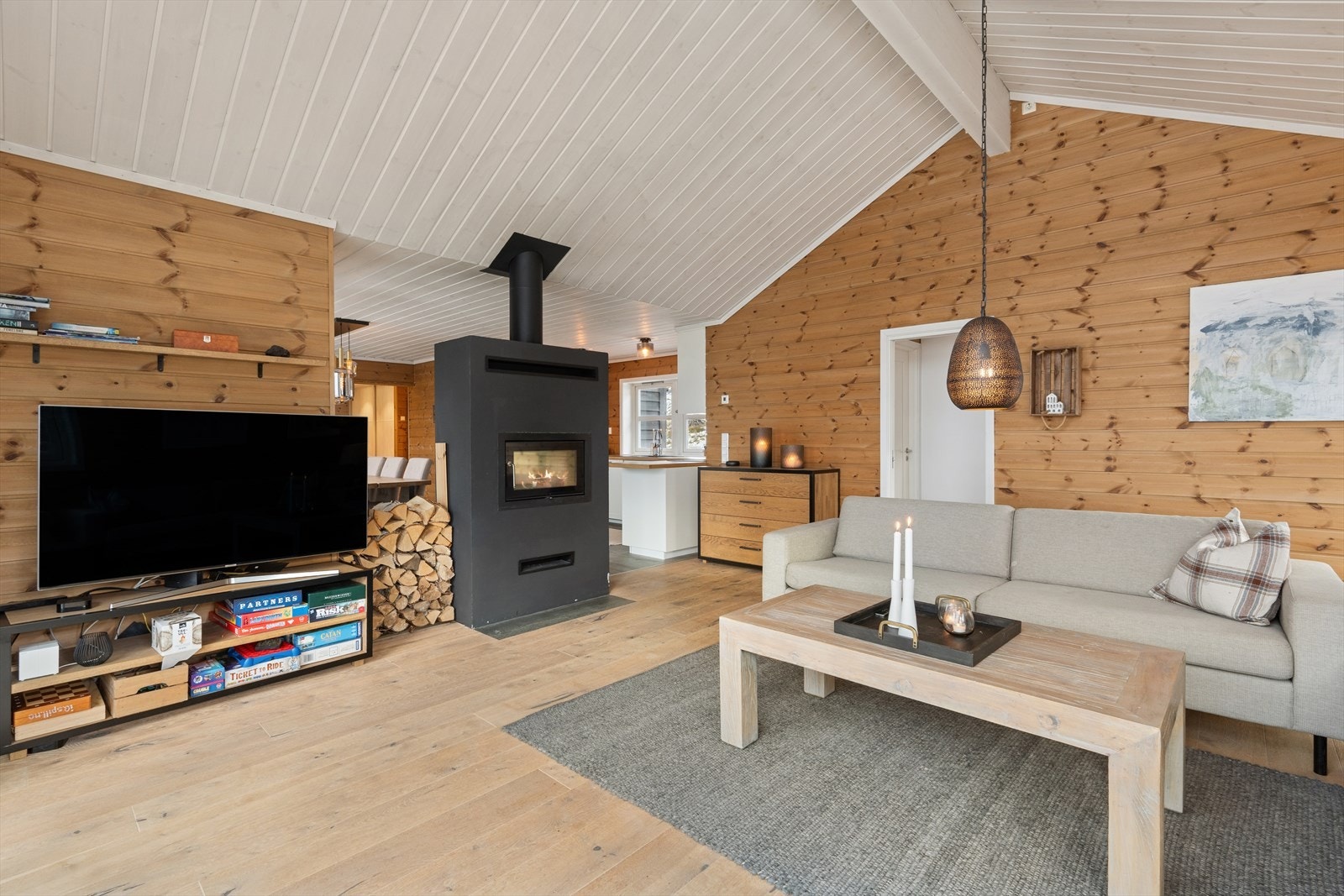 Vedovn med glassdører gir effektiv oppvarming og innsyn fra stue og spisestue. Galleribilde