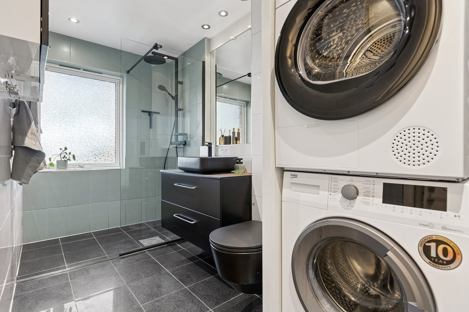 Funksjonelt bad med opplegg for vaskemaskin og tørketrommel. Galleribilde