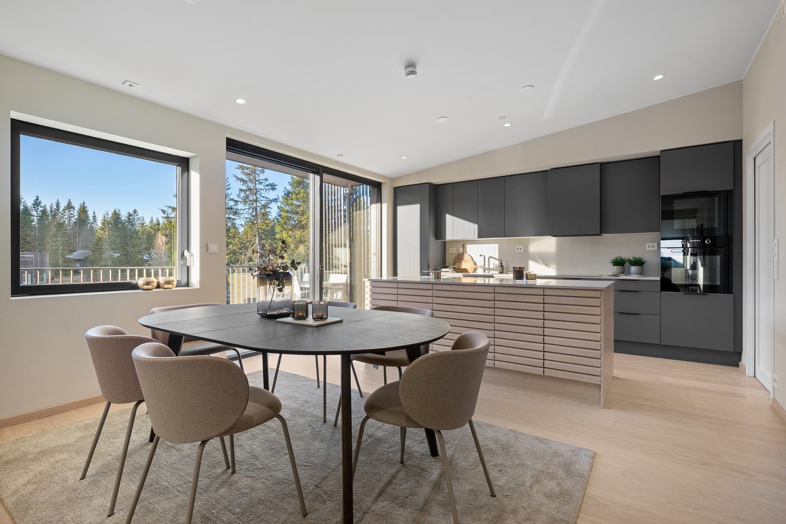 Lekkert og romslig kjøkken fra HTH med kompositt benkeplate, integrerte hvitevarer og stor kjøkkenøy. Galleribilde