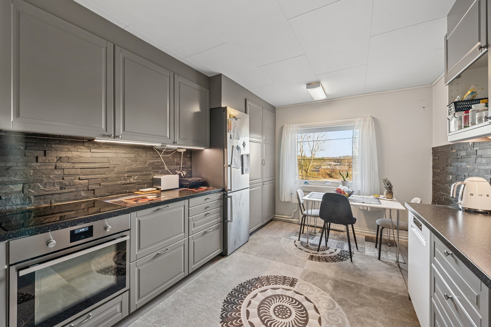 Romslig kjøkken praktisk plassert i et eget rom. Her er det plass til et hyggelig frokostbord ved vinduet. Galleribilde