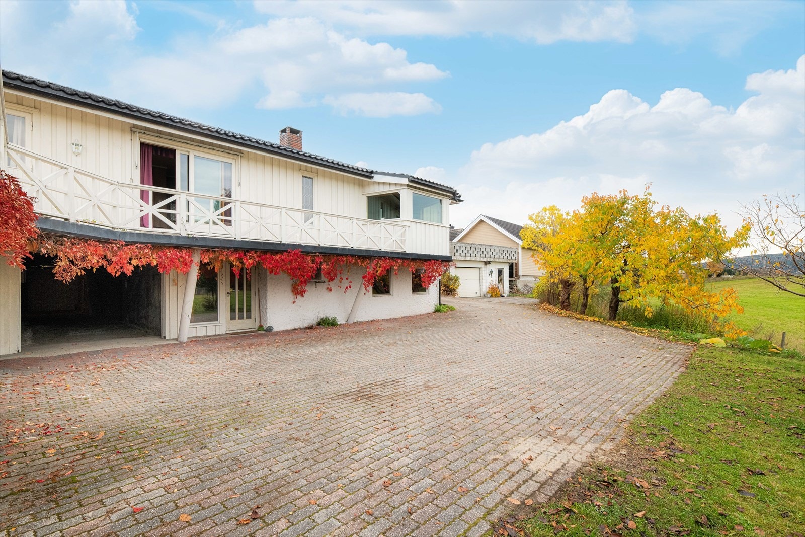 Det er både tilliggende garasje, carport og frittstående garasje på eiendommen. Galleribilde