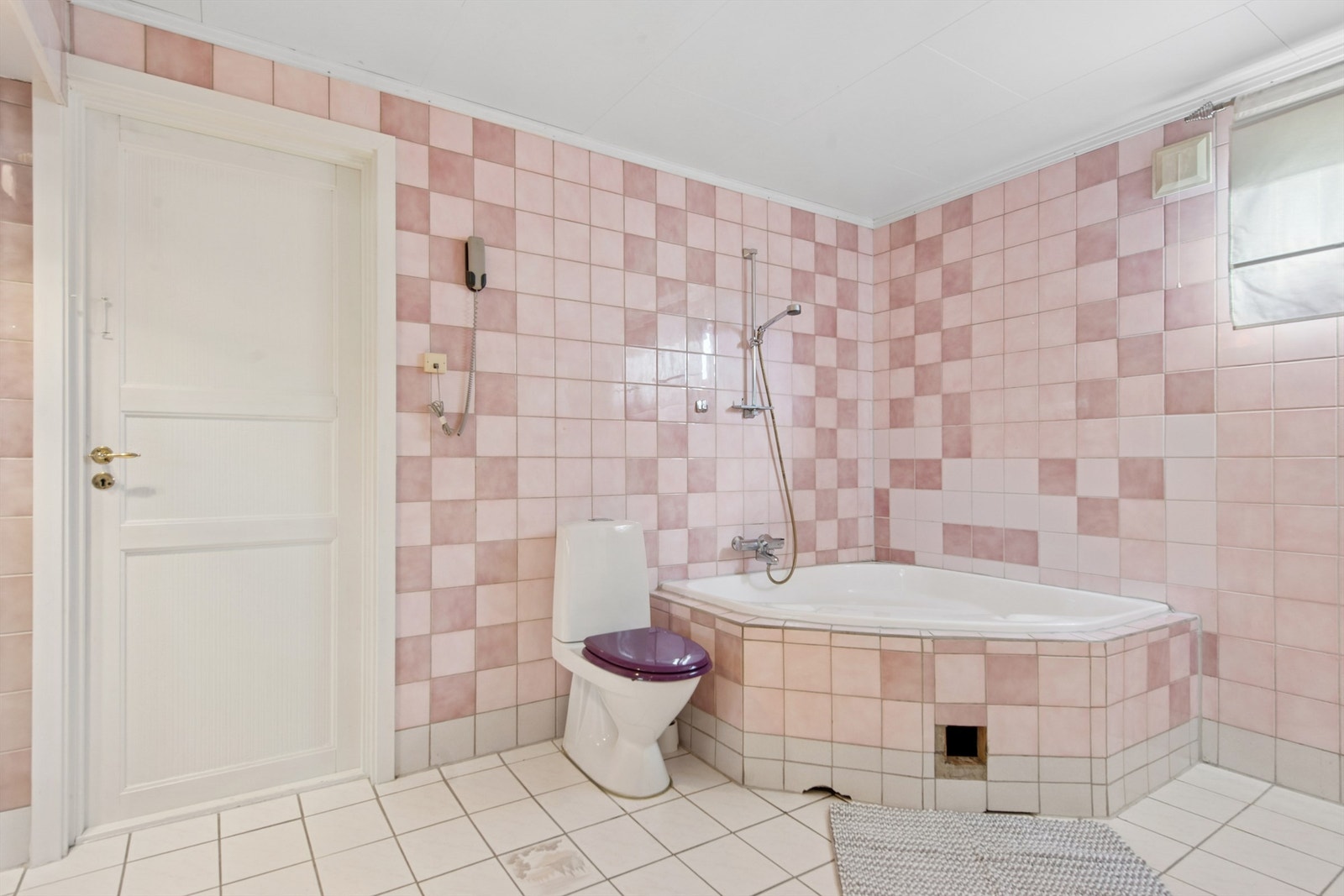 Stort flislagt bad i kjeller. Elektrisk gulvvarme. Rommet er innredet med stort innmurt hjørnebadekar og toalett. Galleribilde