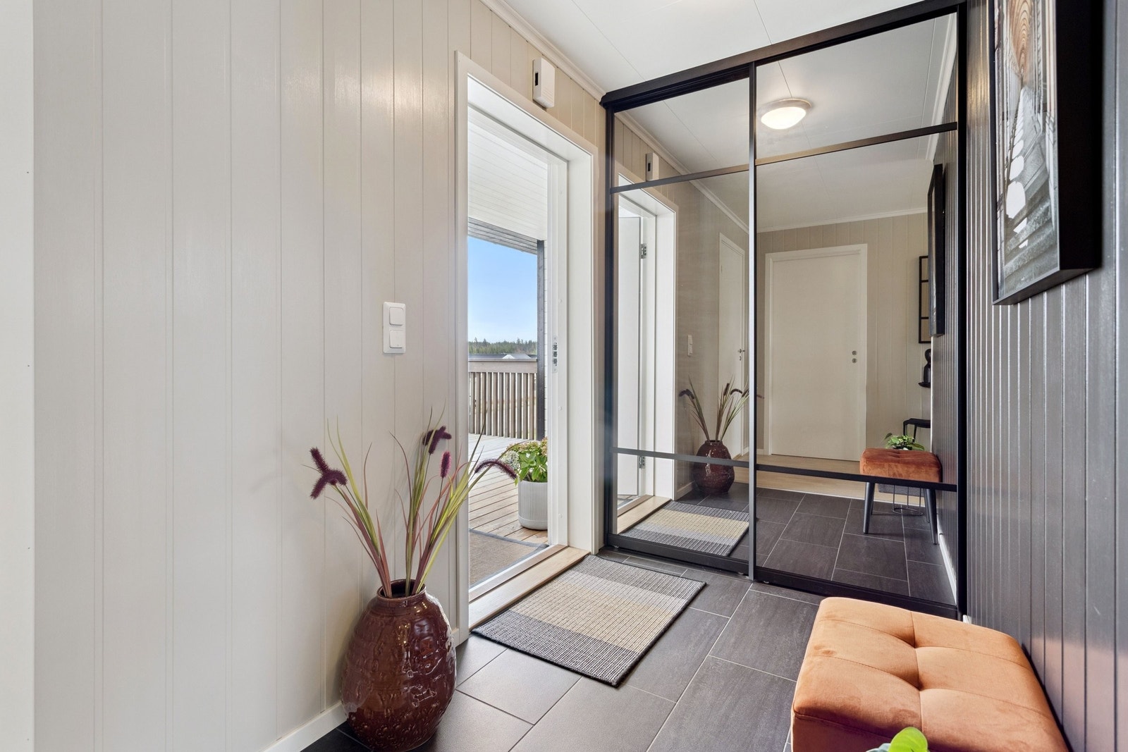 Velkommen til Damtjernvegen 1D - Entréen har mørke fliser og skyvedørsgarderobe med speildører. Galleribilde