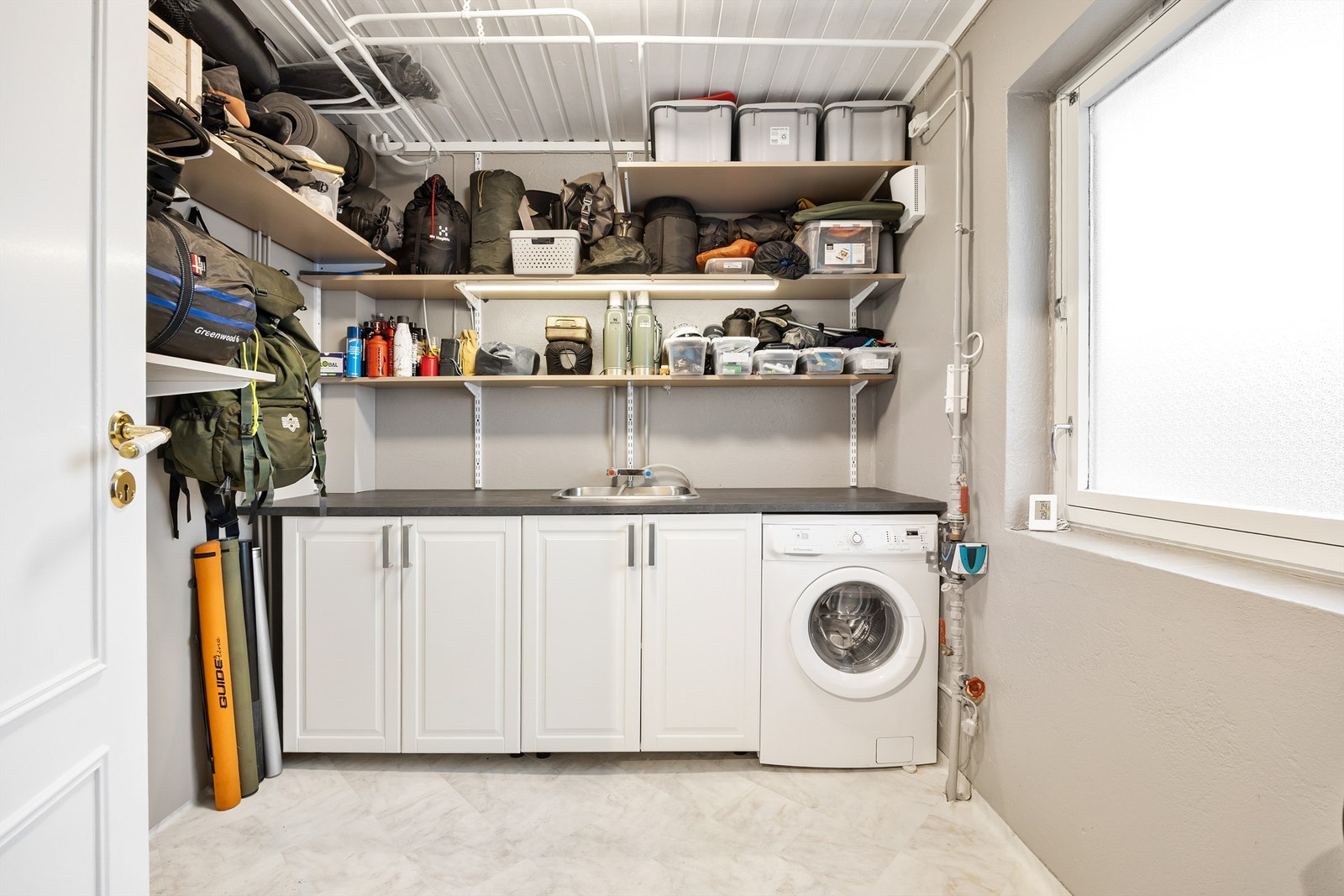 Vaskerommet har rikelig med oppbevaringsplass, vask og opplegg til vaskemaskin Galleribilde