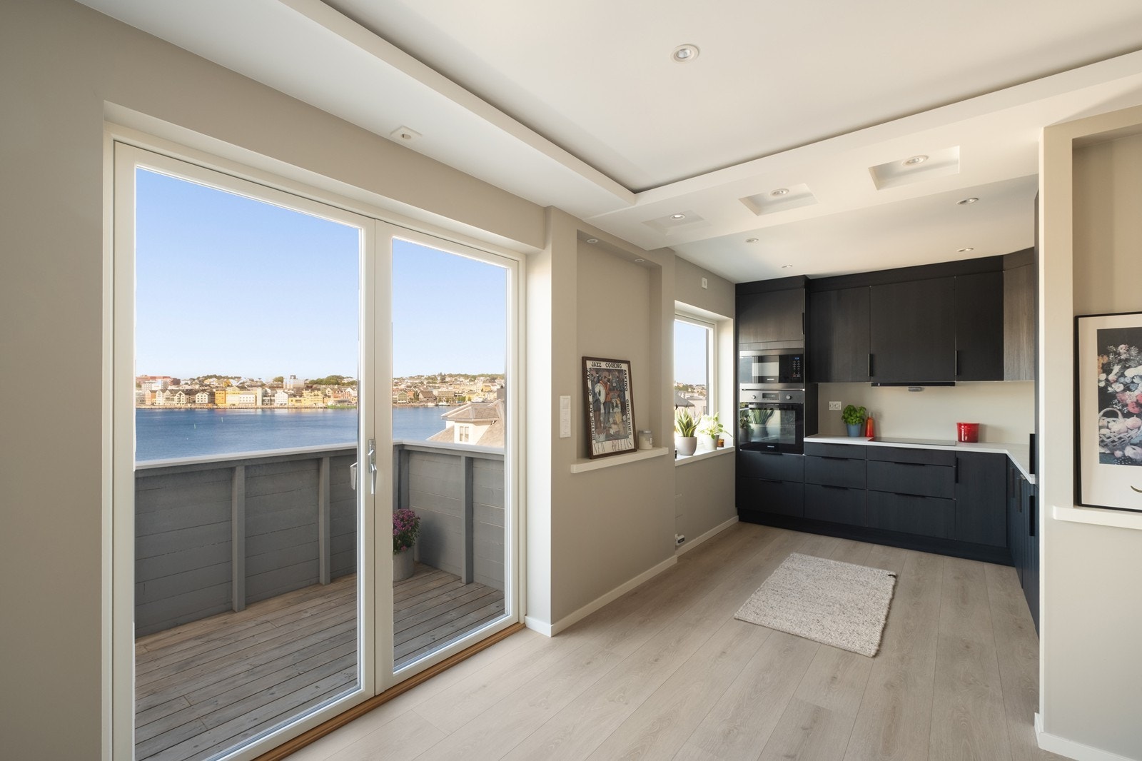 Mellom stue og kjøkken er utgang til verandaen og fantastisk utsikt mot havnebassenget! Galleribilde