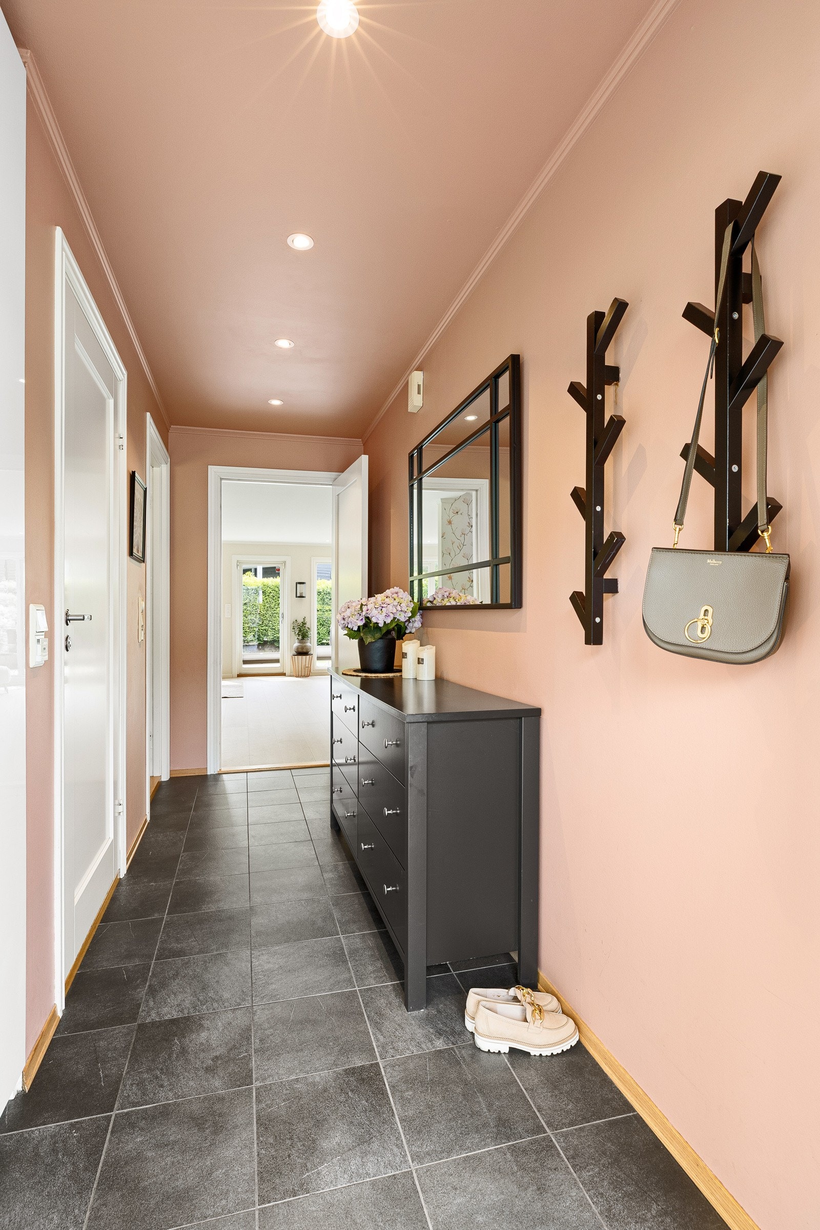 Entréen har malte vegger i freshe farger, fliser på gulvet og downlights, og er innredet med et plassbygd garderobeskap. Galleribilde
