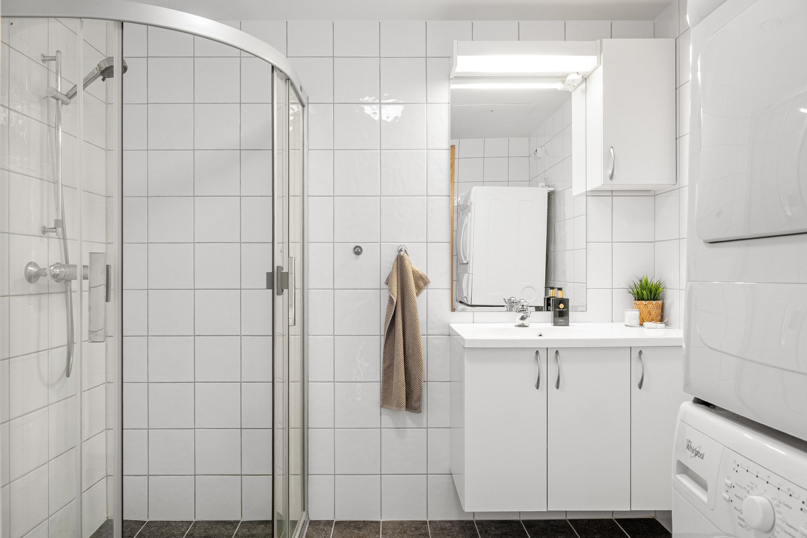 Flislagt bad med opplegg for vaskemaskin og tørketrommel. Galleribilde