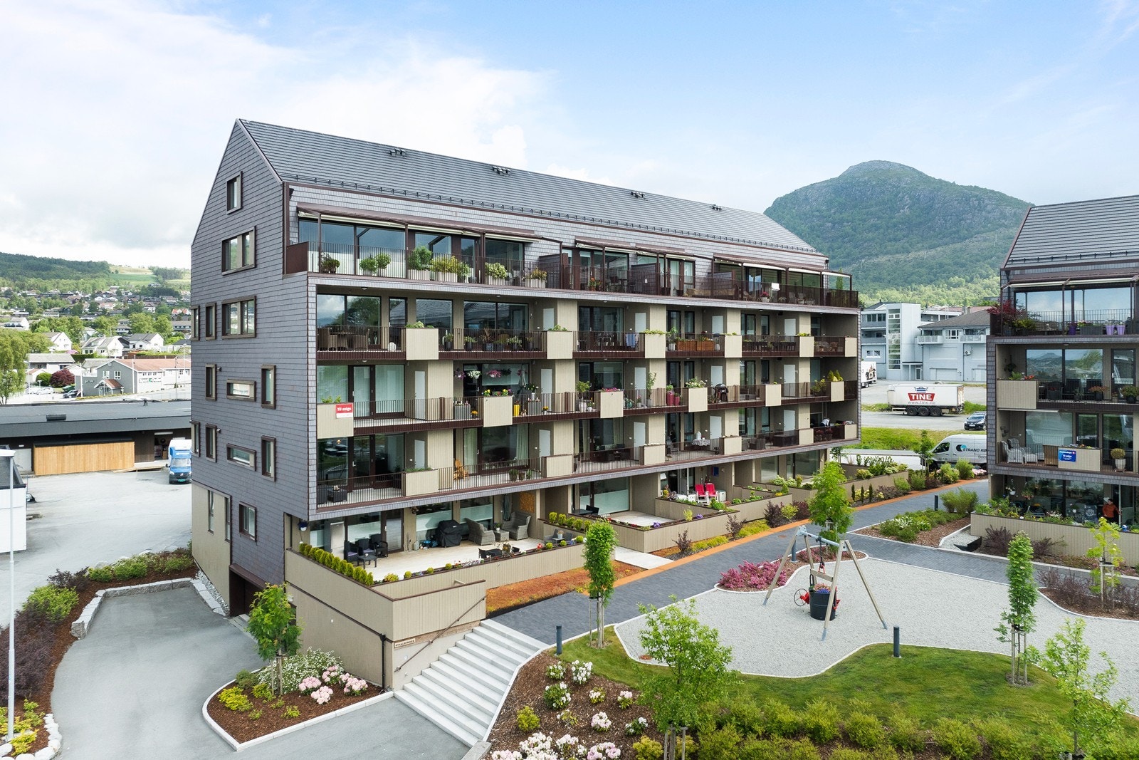 Bygningen er omgitt av velstelte grøntområder og har en moderne arkitektur. Galleribilde