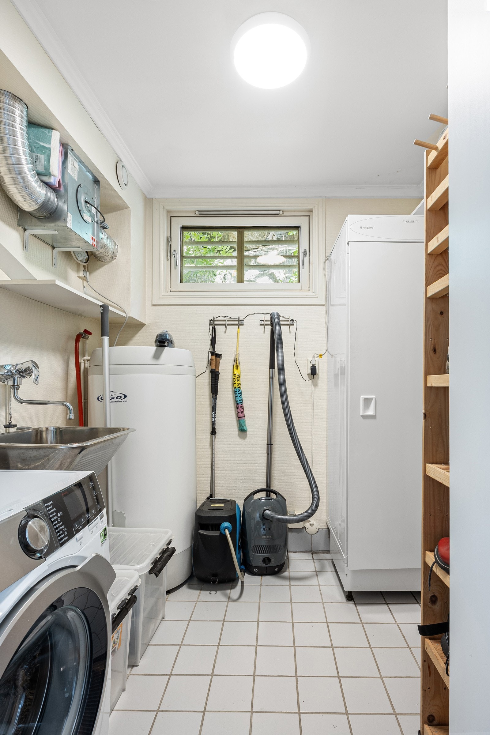 Vaskerommet har adkomst fra entreen, vindu mot øst, flislagt gulv og vaskekum i stål. Varmtvannsbereder er fra 2007. Galleribilde