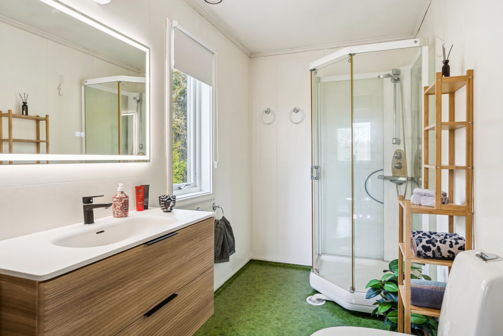 Badet i første etasje i kårboligen har nyere baderomsinnredning i moderne design, samt toalett og dusjkabinett. Galleribilde