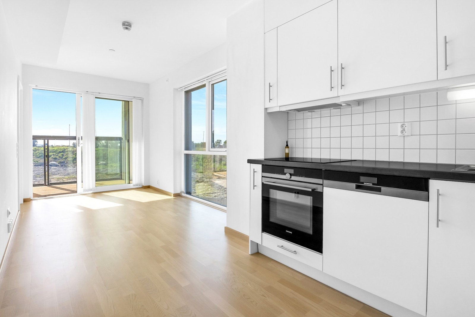 Leiligheten har en åpen stue/kjøkkenløsning. Galleribilde