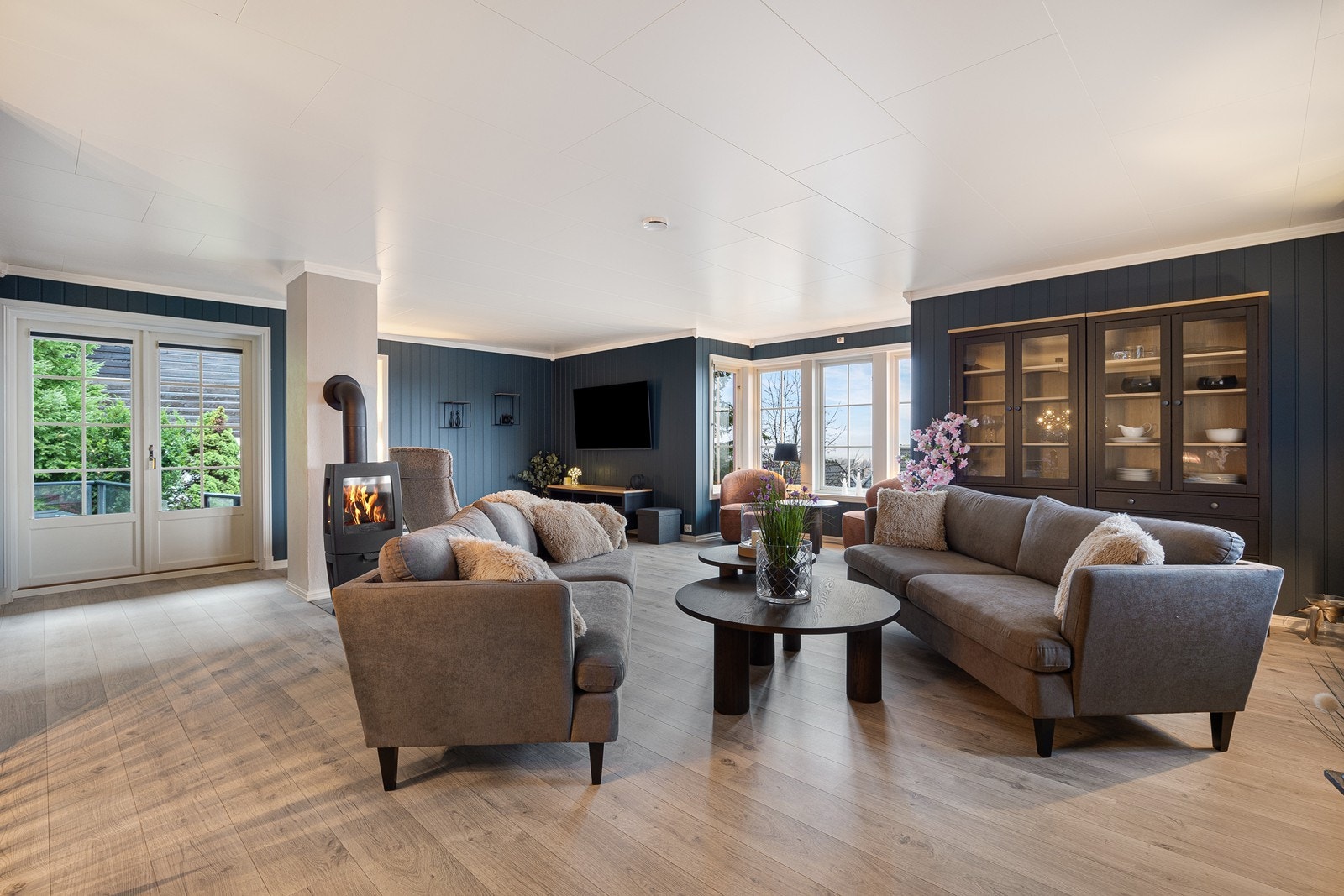 Store vindusflater gir utsyn mot hageområde fra stuen. Galleribilde