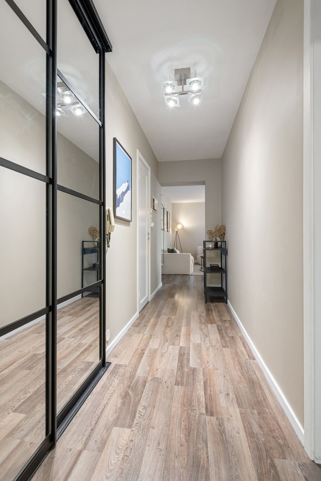 Lys og innbydende gang med moderne detaljer og stilrent design, som gir et godt førsteinntrykk av boligen. Galleribilde