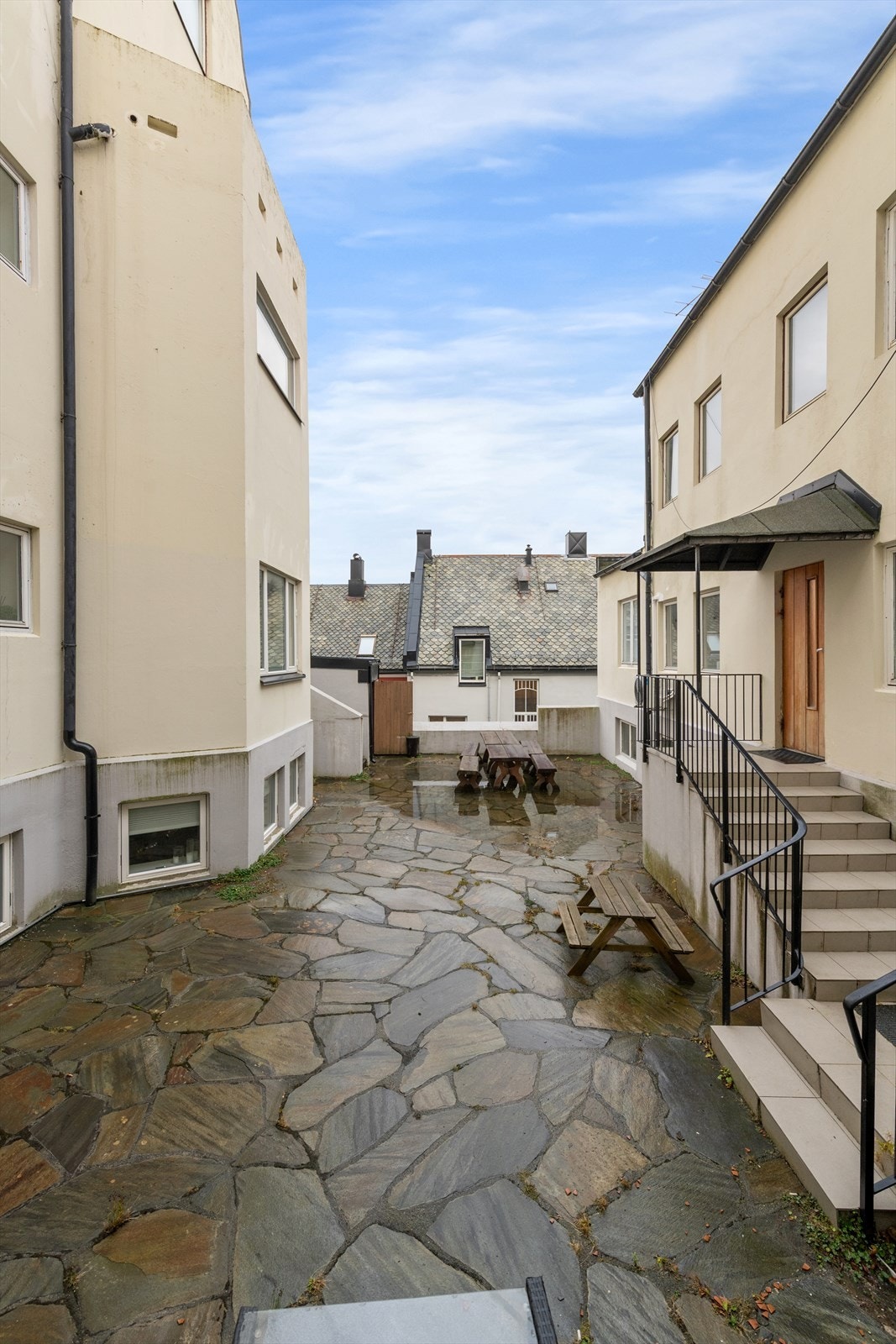 Sjarmerende gårdsplass med steinlagt underlag, perfekte for utendørs samlinger. Rolig beliggenhet nær sentrum, med kort vei til fasiliteter. Galleribilde