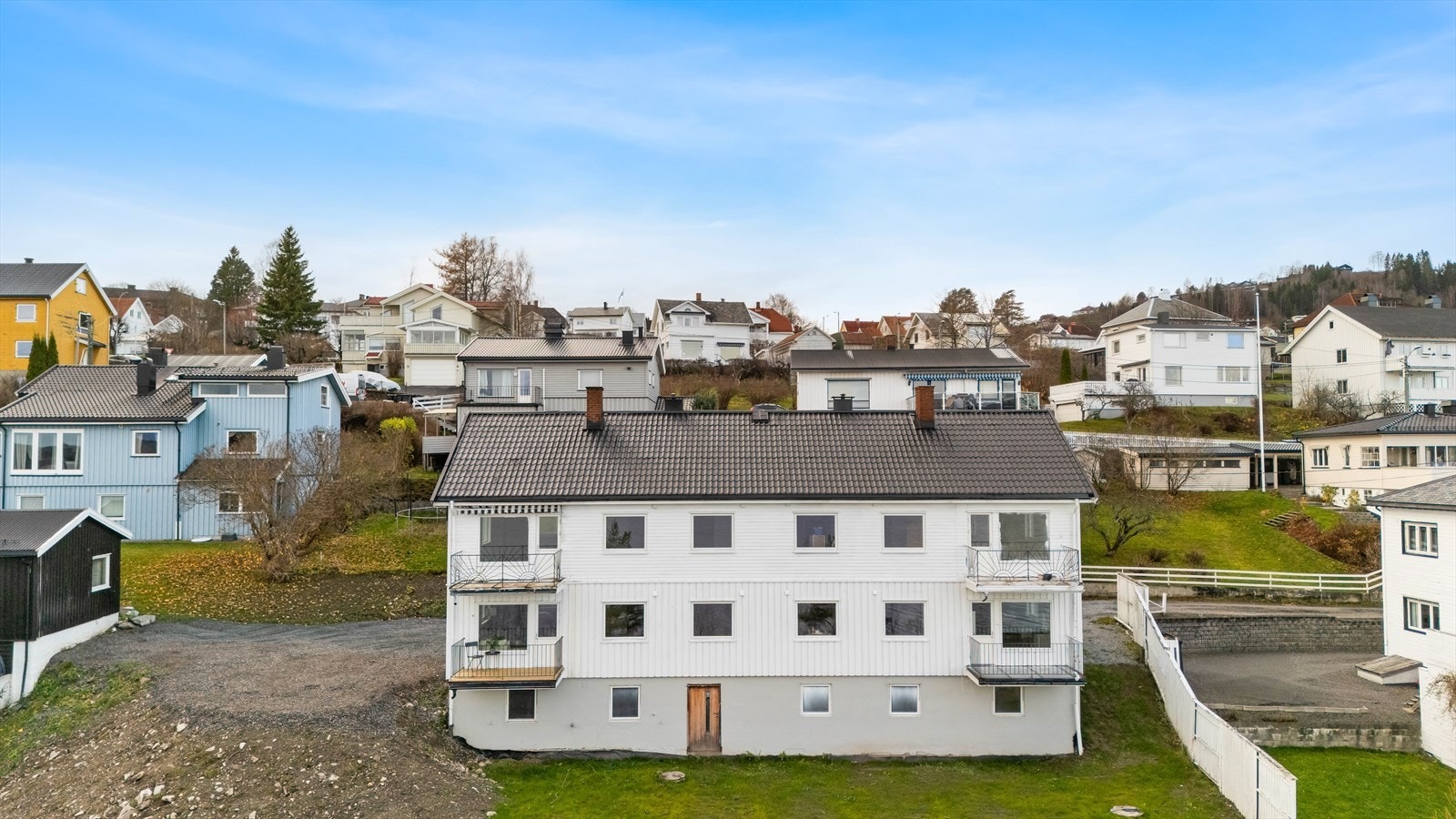 Fasadebilde av bygget med plenarealer i front. Galleribilde