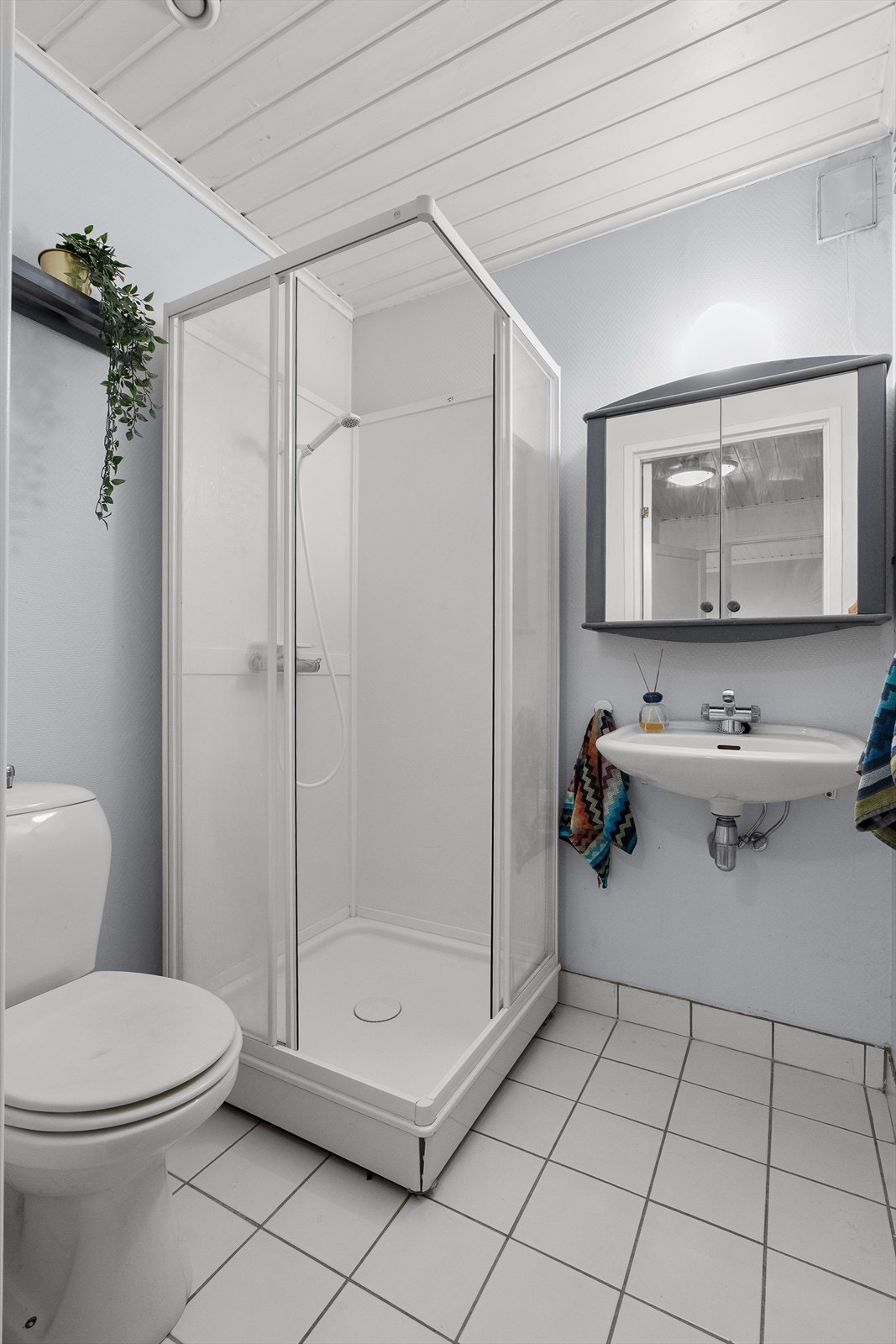 Badet er praktisk innredet med toalett, servant og dusjkabinett. Galleribilde