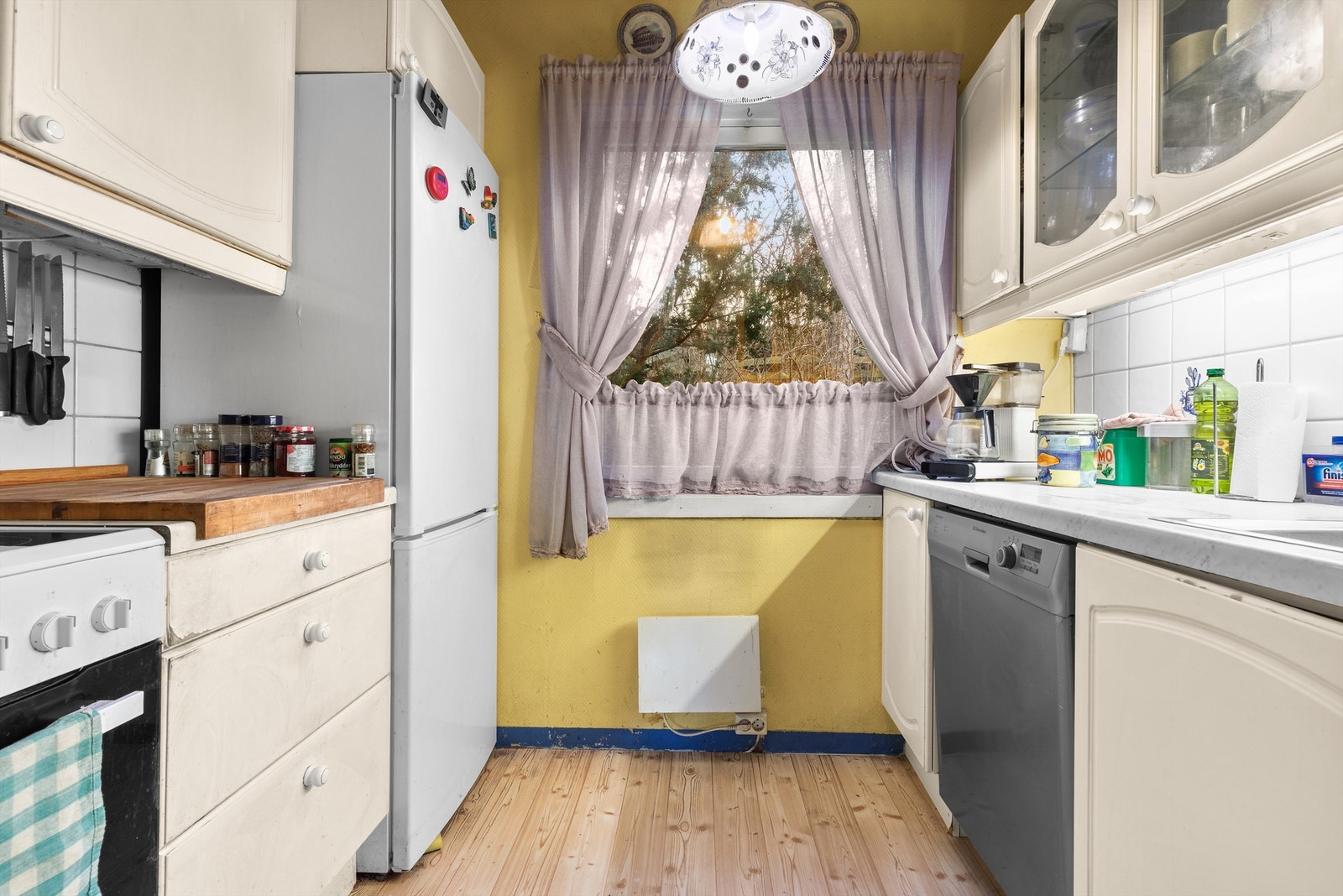 Kjøkkenet i første etasje har innredning med profilerte, lyse fronter og laminatbenkeplate. Galleribilde