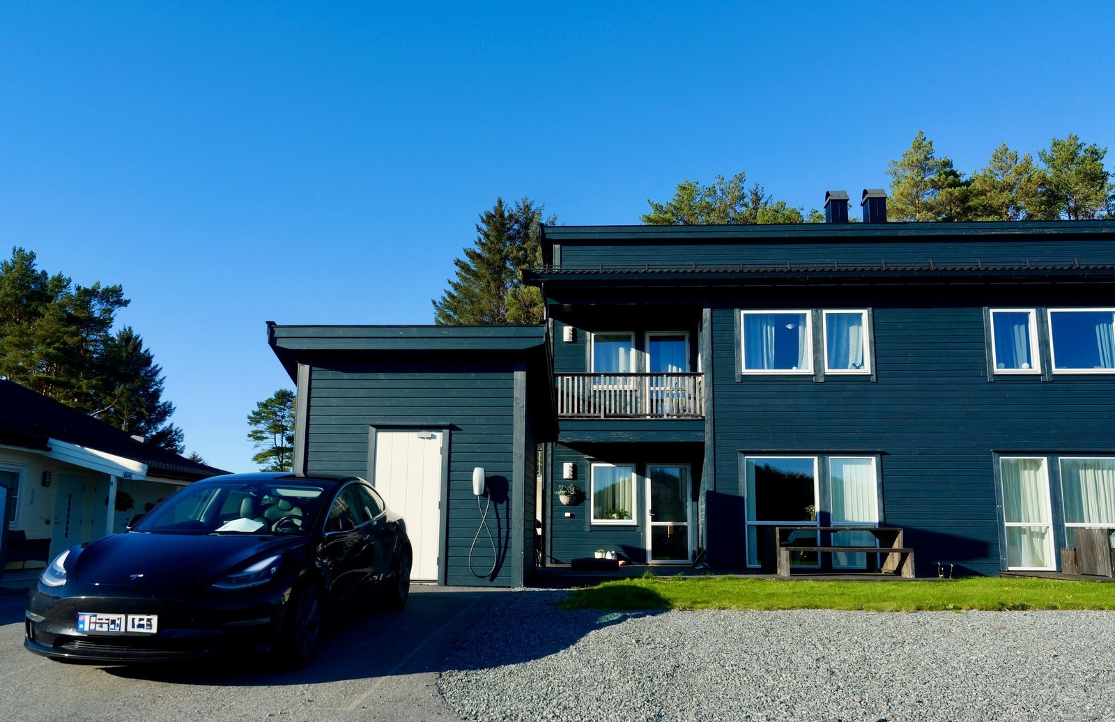 Pen fasade i tre med utebod. På eiendommen er det plass til tre bilar, i tillegg til plen og terrasse. Galleribilde