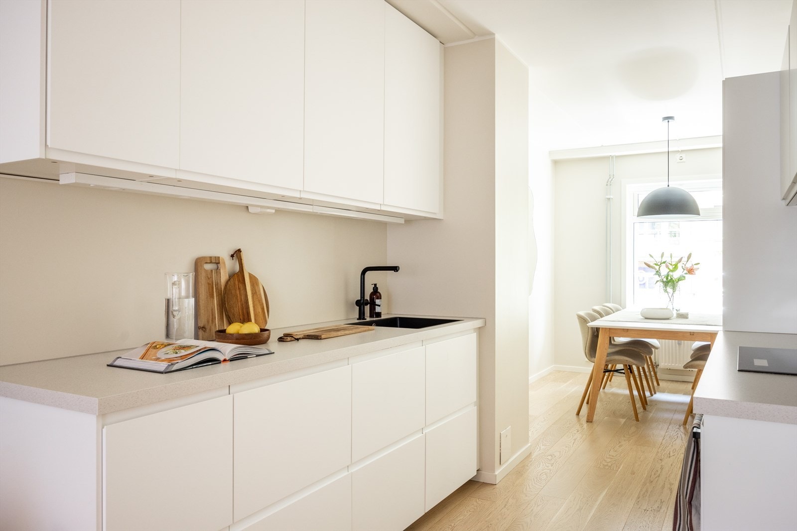 Kjøkkeninnredningen består av hvite, glatte fronter og benkeplate av laminat med nedfelt vaskekum. Galleribilde