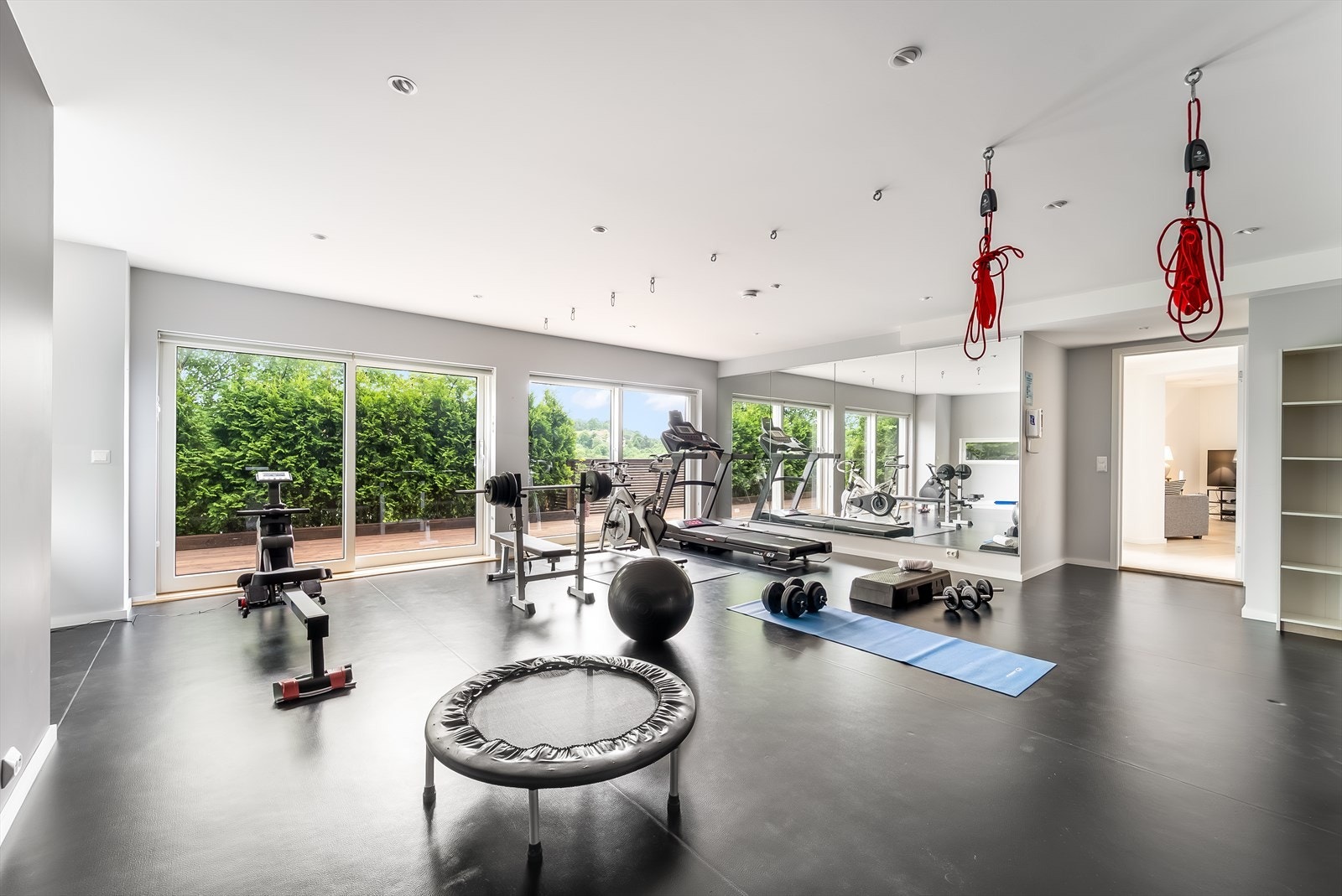 Stort treningsrom med plass til flere treningsapparater og oppheng til slynger. Støtdempende underlag. Galleribilde